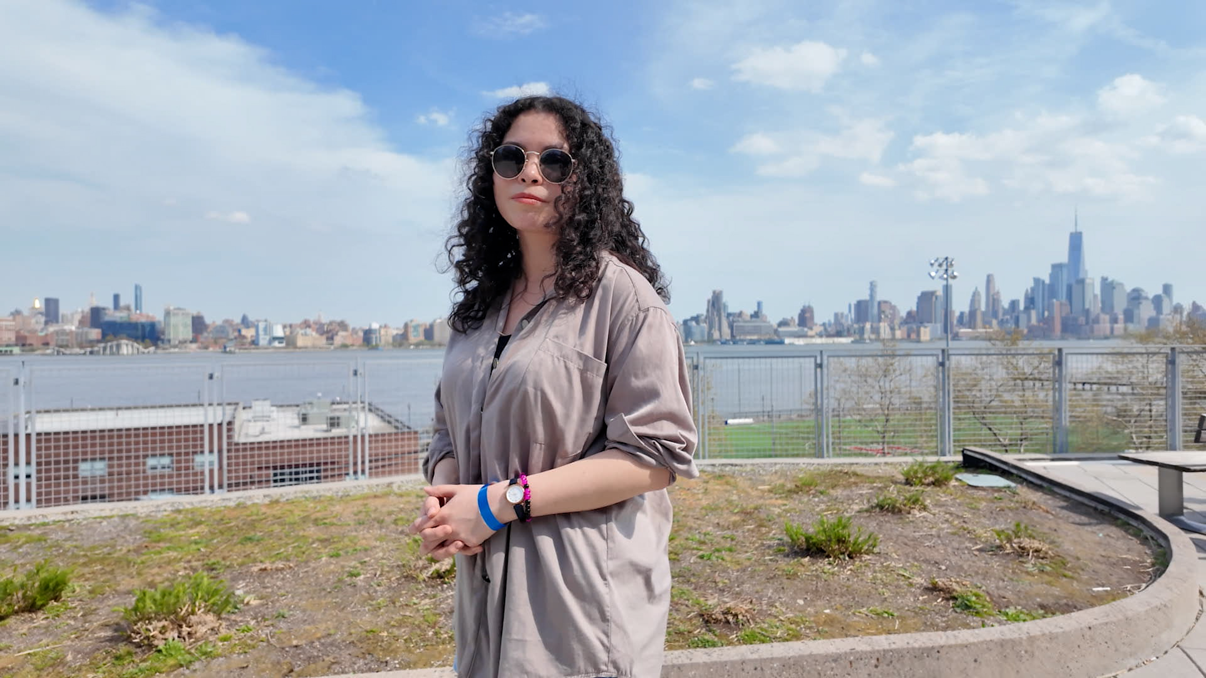 Emily Lossman posing in front of the NYC skyline.