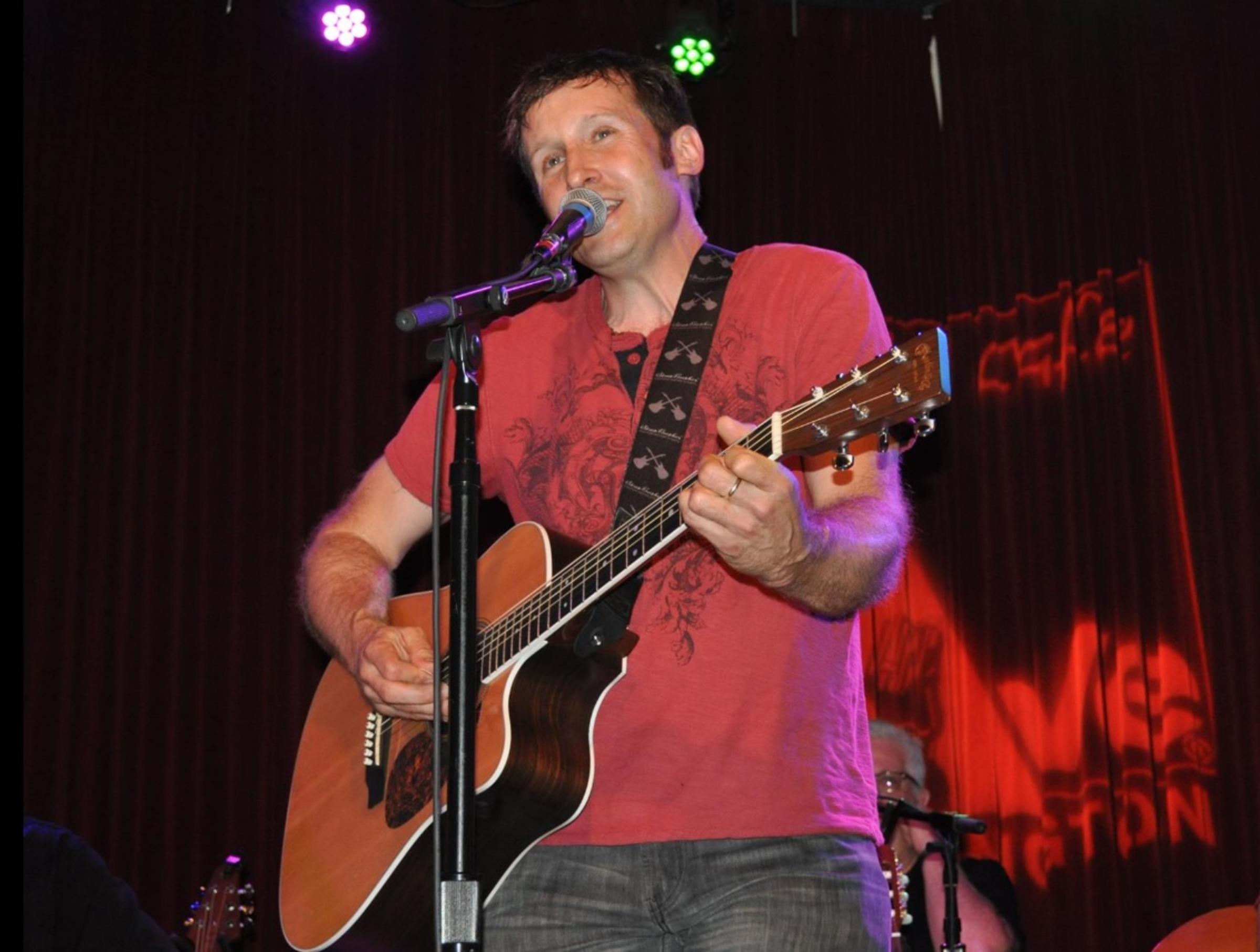 Chuck Schaeffer performing on stage singing