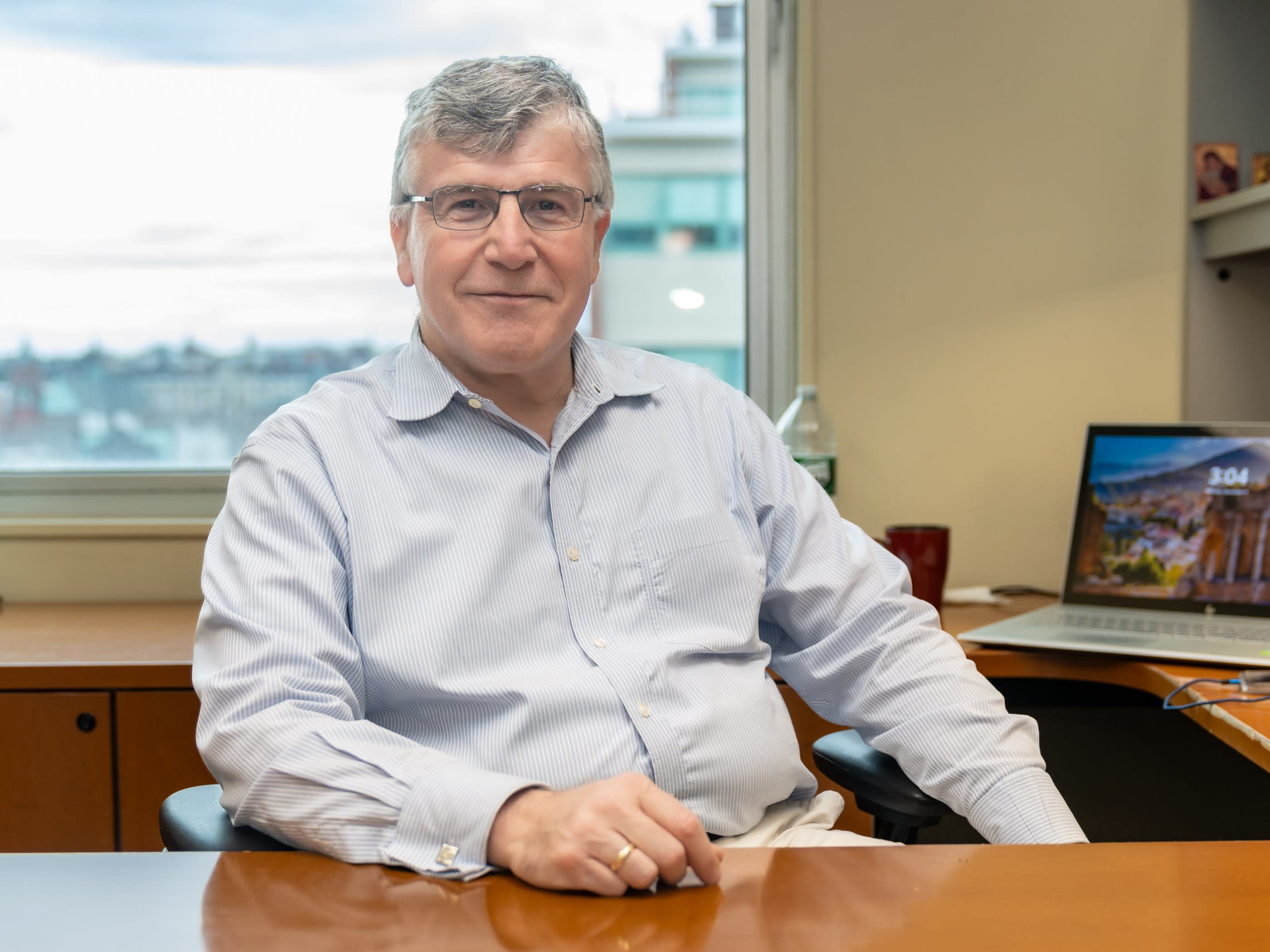 Emmanuel Hatzakis sits behind his desk.