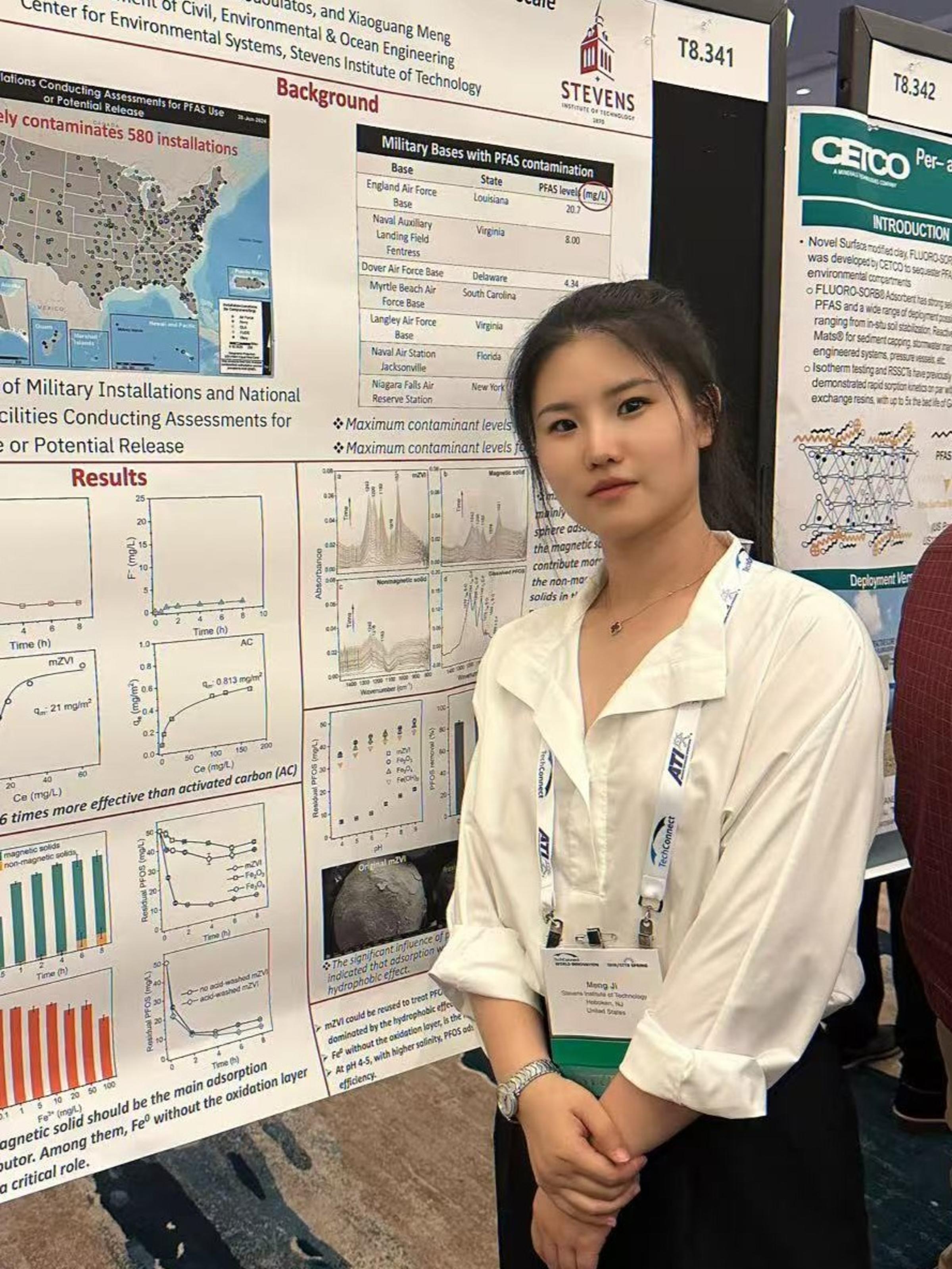 A photo of Meng Ji posing in front of her research poster.