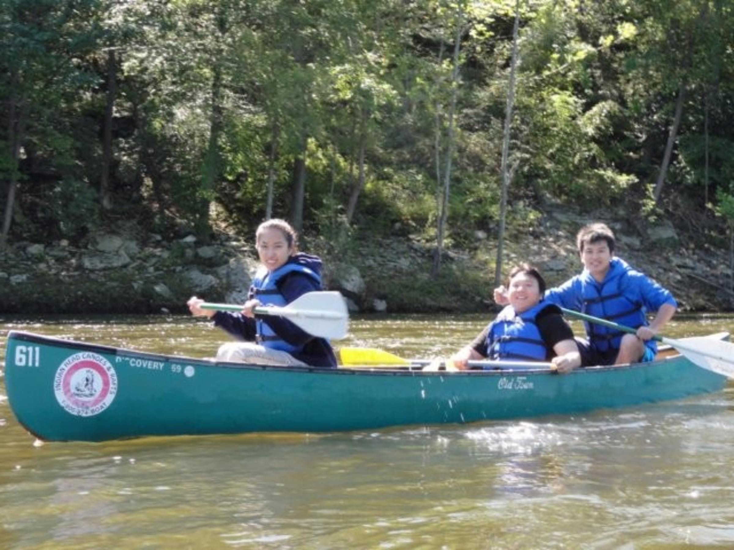 3 individuals in a canoe
