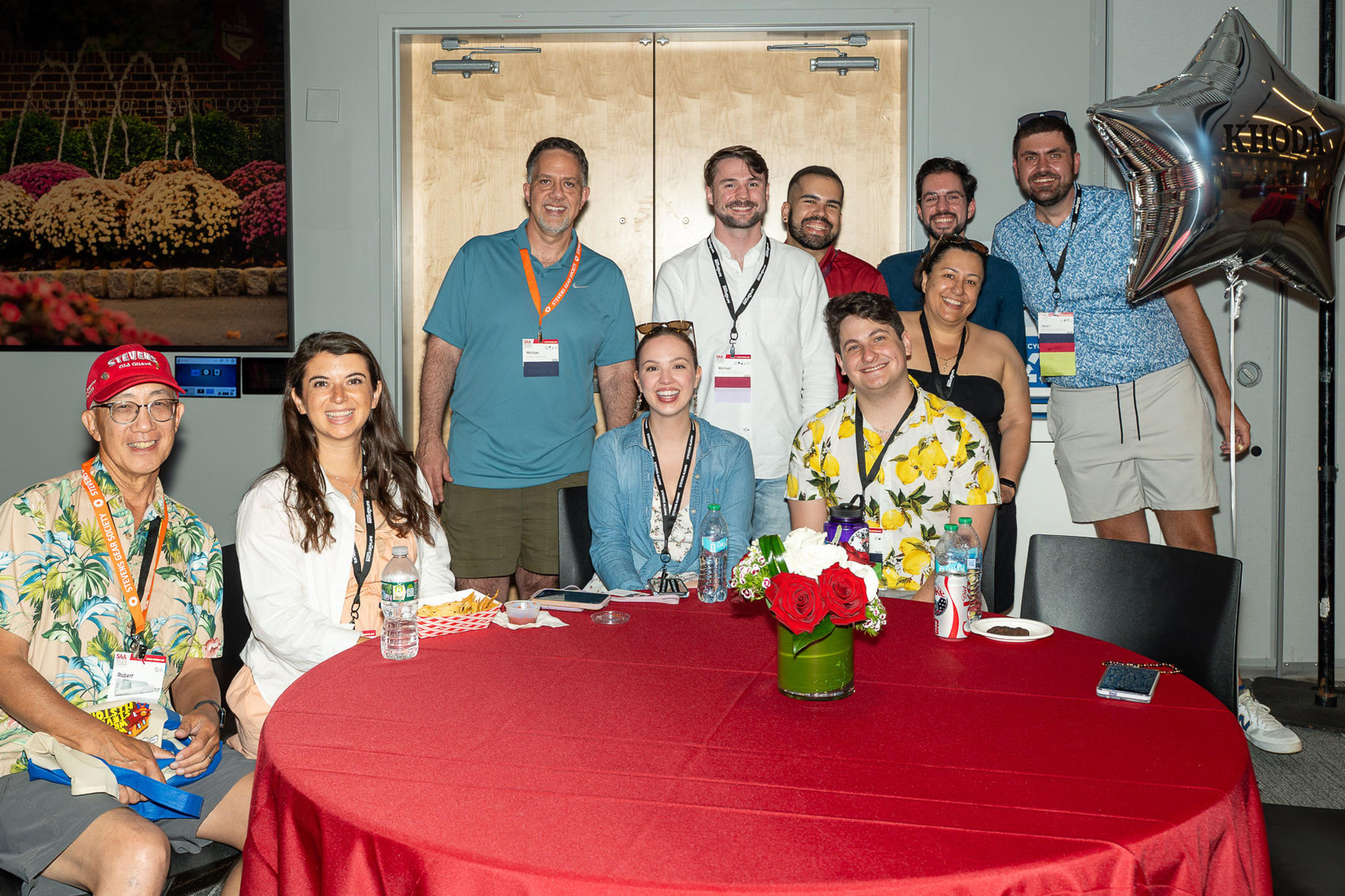 Group of alumni around a table indoors at Alumni Weekend 2026