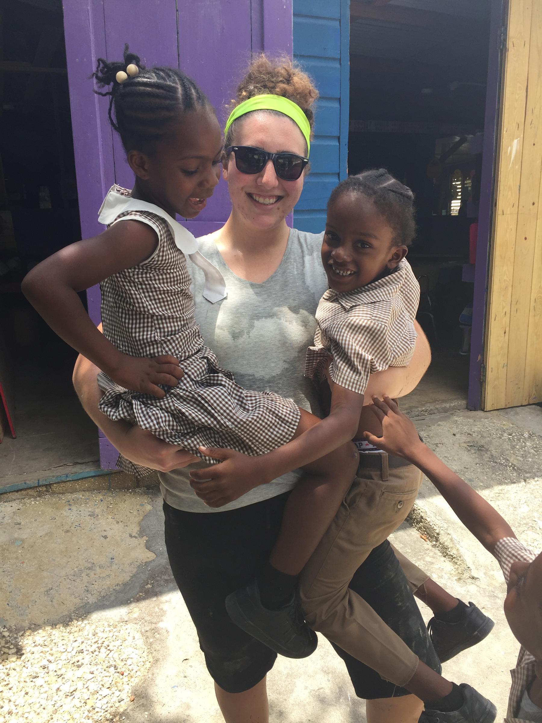 Olivia Schreiber in Jamaica holding 2 children