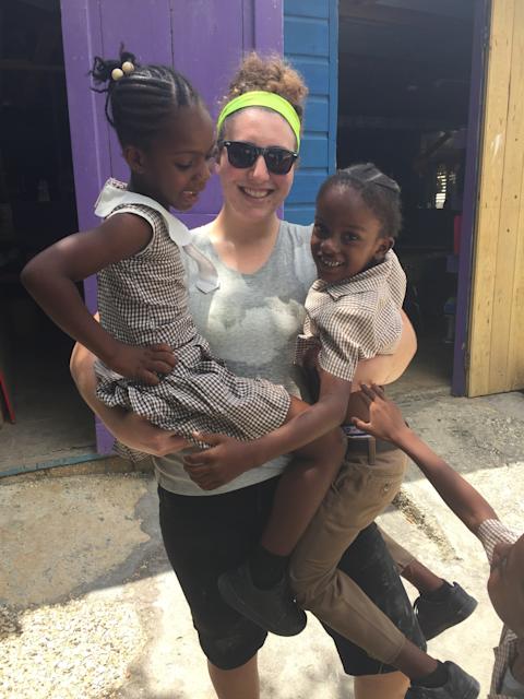 Olivia Schreiber in Jamaica holding 2 children