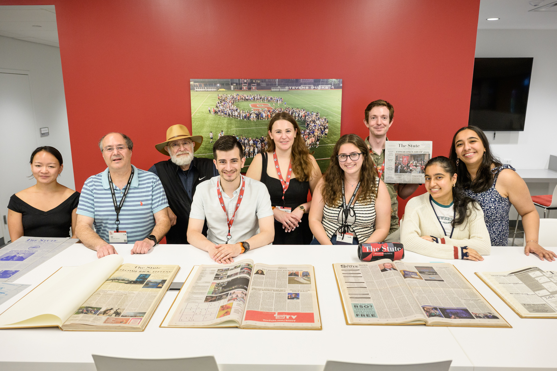The Stute Affinity Group gathers at Alumni Weekend 2025 and poses with older editions of the newspaper