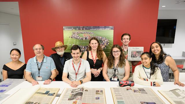 The Stute Affinity Group gathers at Alumni Weekend 2025 and poses with older editions of the newspaper