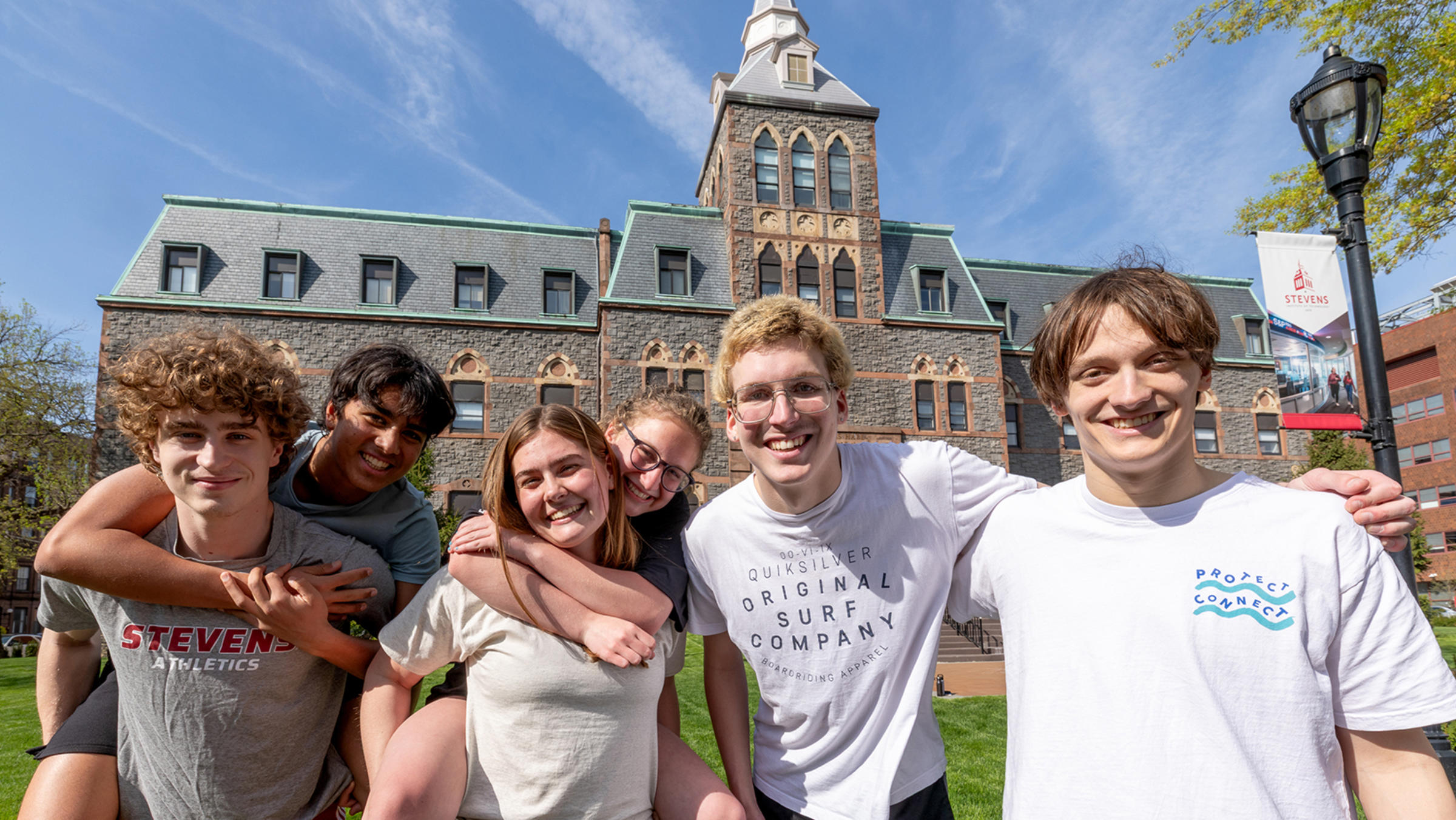Students smile and gather in front of the EAS Building