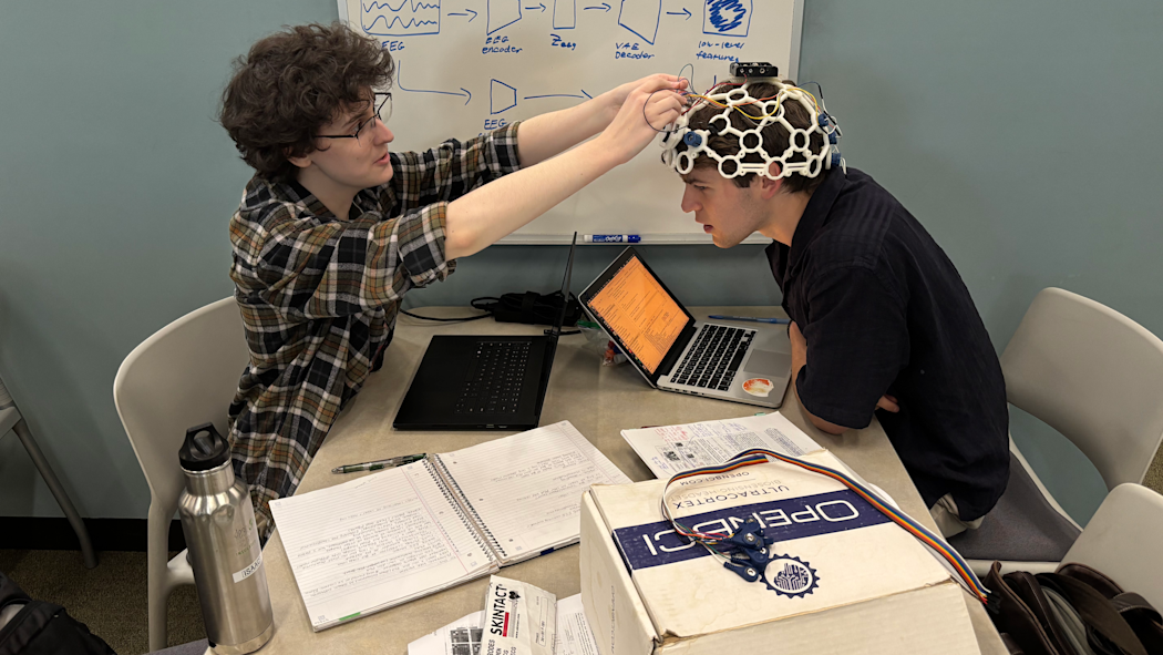 Issac Van Benthuysen on the left and Jack Caputo on the right working on their EEG machine.
