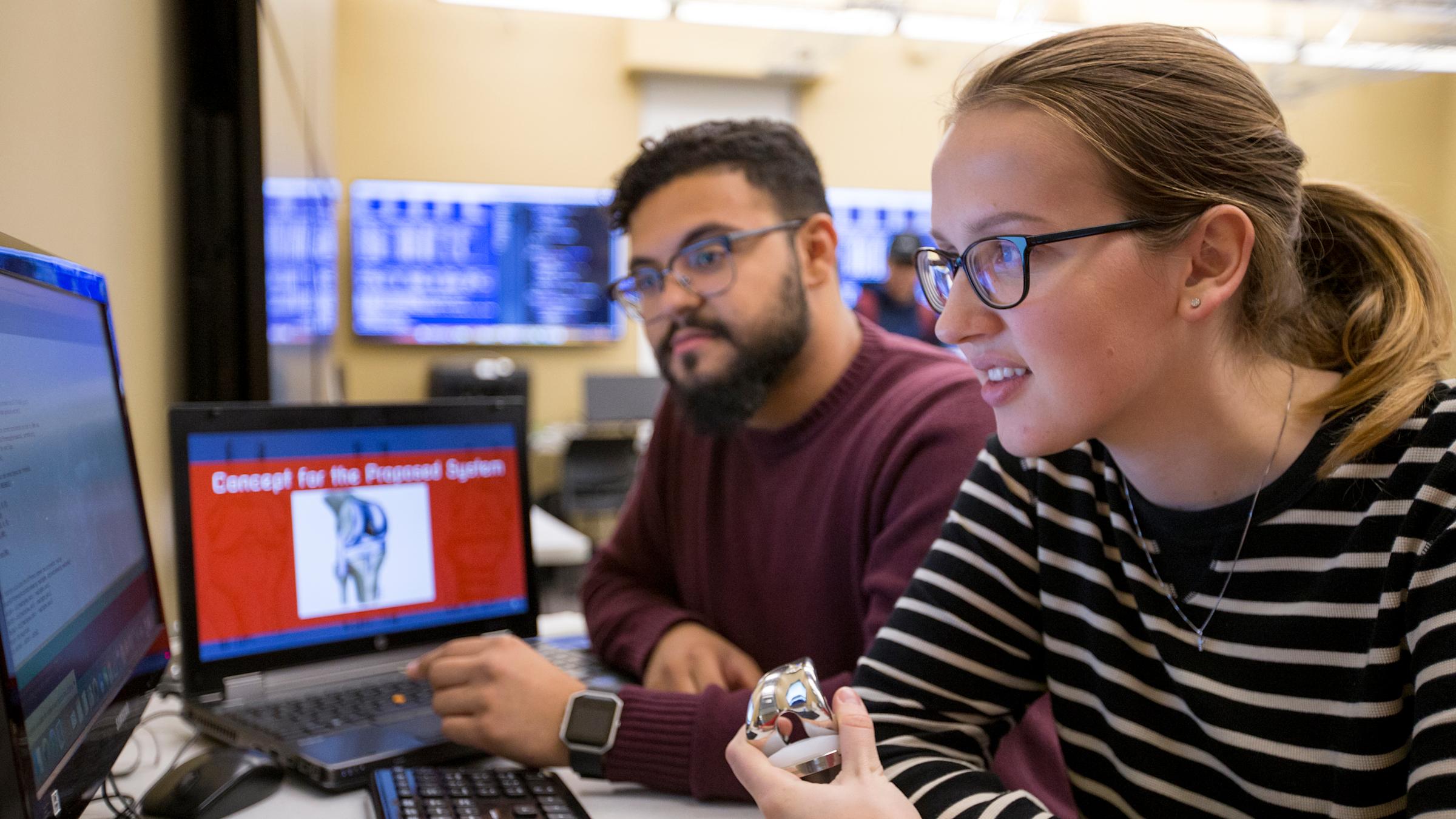 2 Computer Science students working on computers