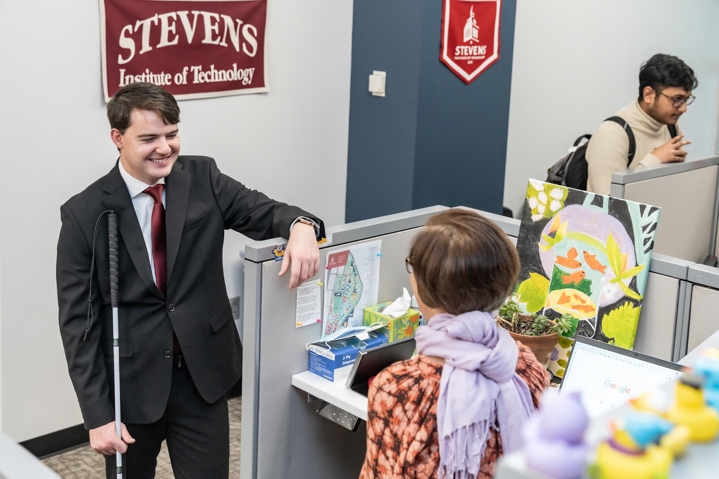 Robert Dahill stands outside Lisa Cavanaugh's cubicle in the Center for Student Success. 