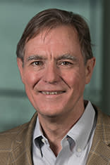 Headshot of Dr. Jeff Nickerson in a light jacket and blue shirt against the New York City skyline.