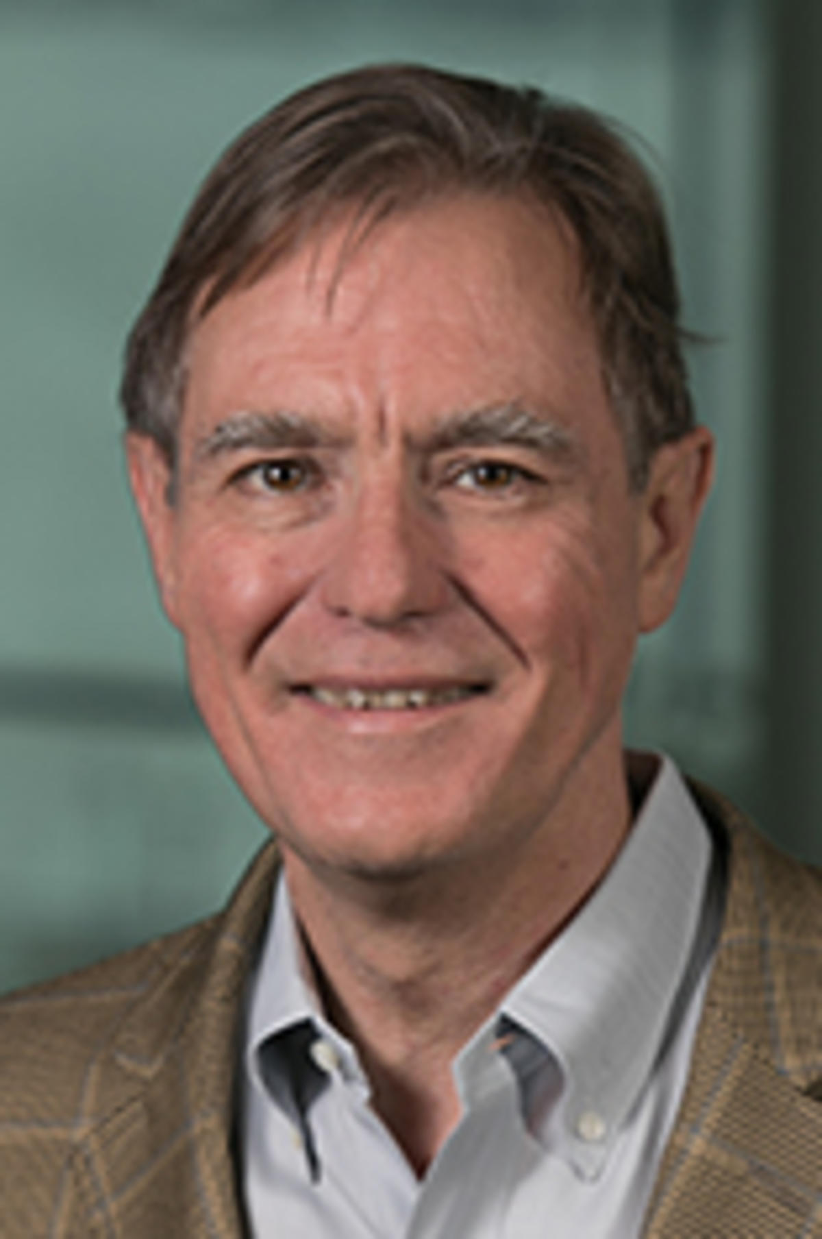 Headshot of Dr. Jeff Nickerson in a light jacket and blue shirt against the New York City skyline.