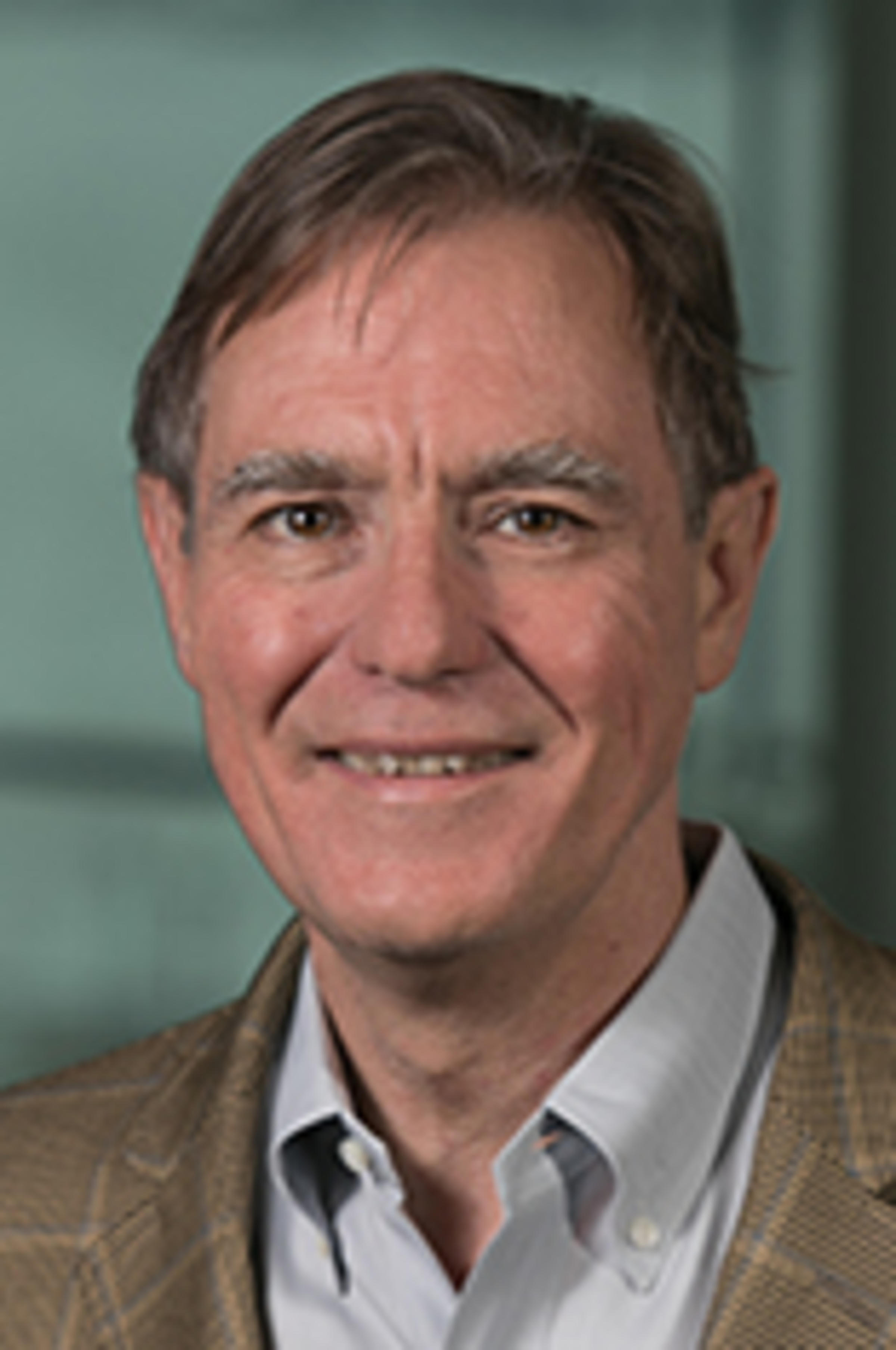 Headshot of Dr. Jeff Nickerson in a light jacket and blue shirt against the New York City skyline.