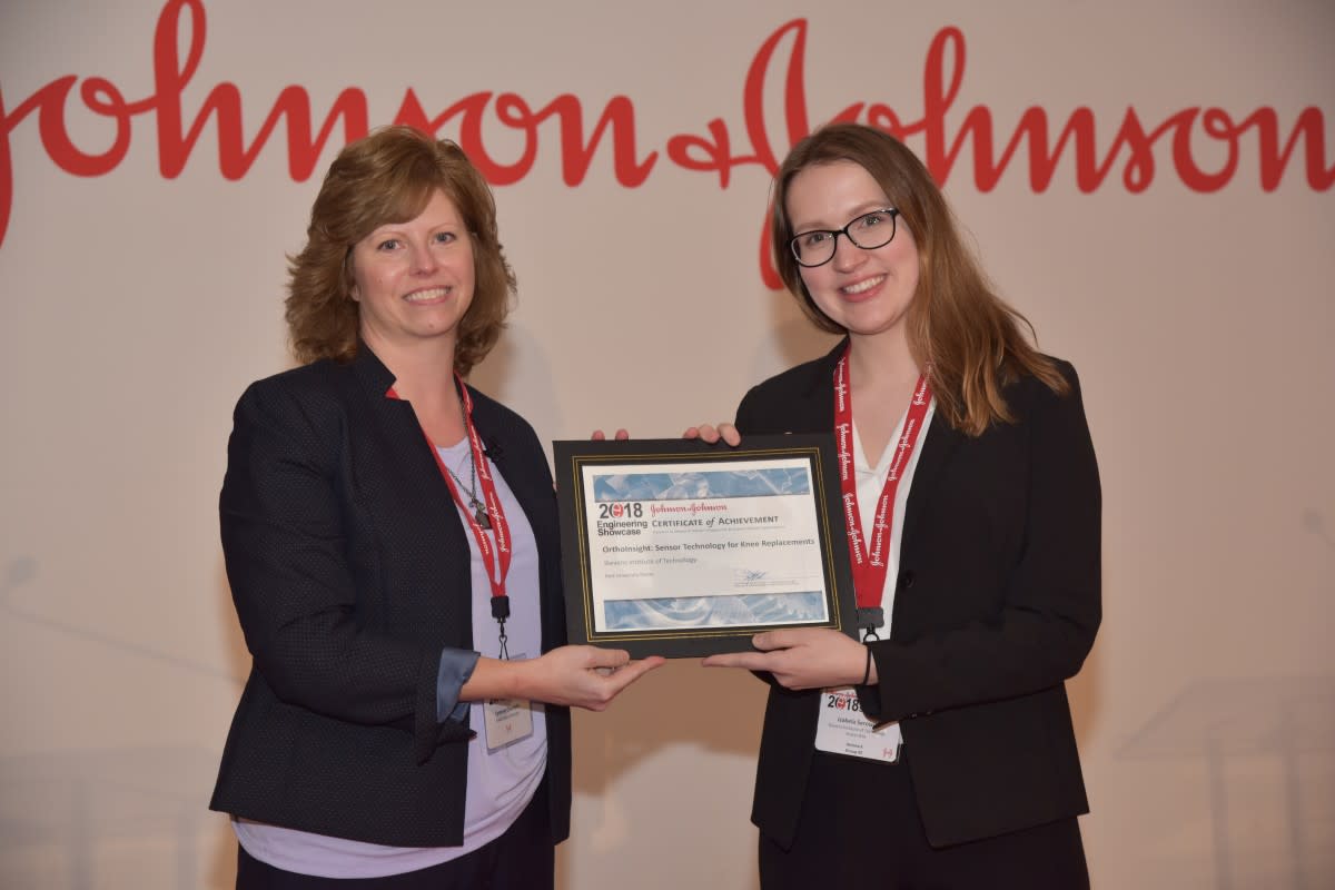 Serowik accepting the award on behalf of the team at the J&J showcase.