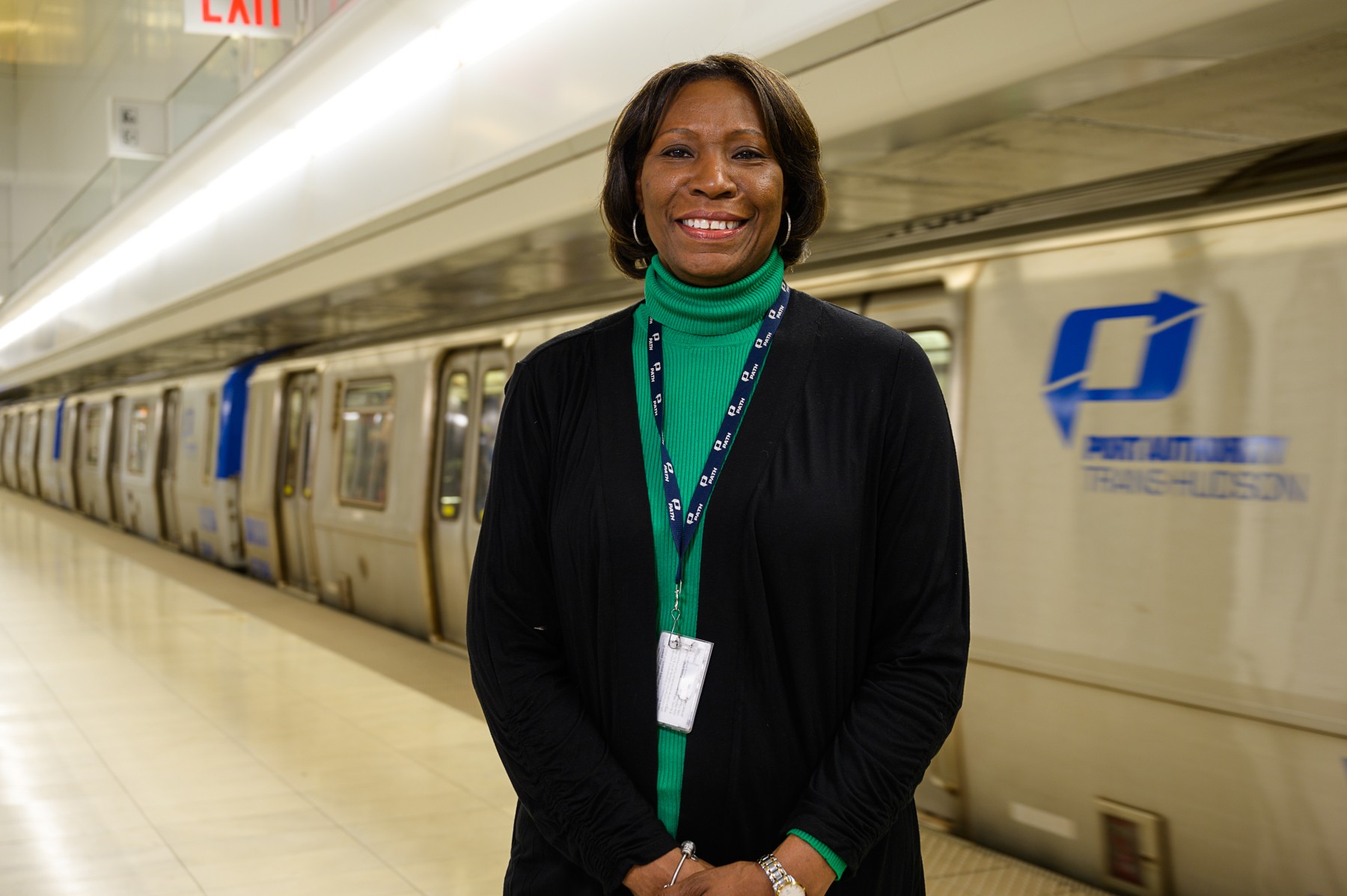 Clarelle DeGraffe standing next to a PATH train