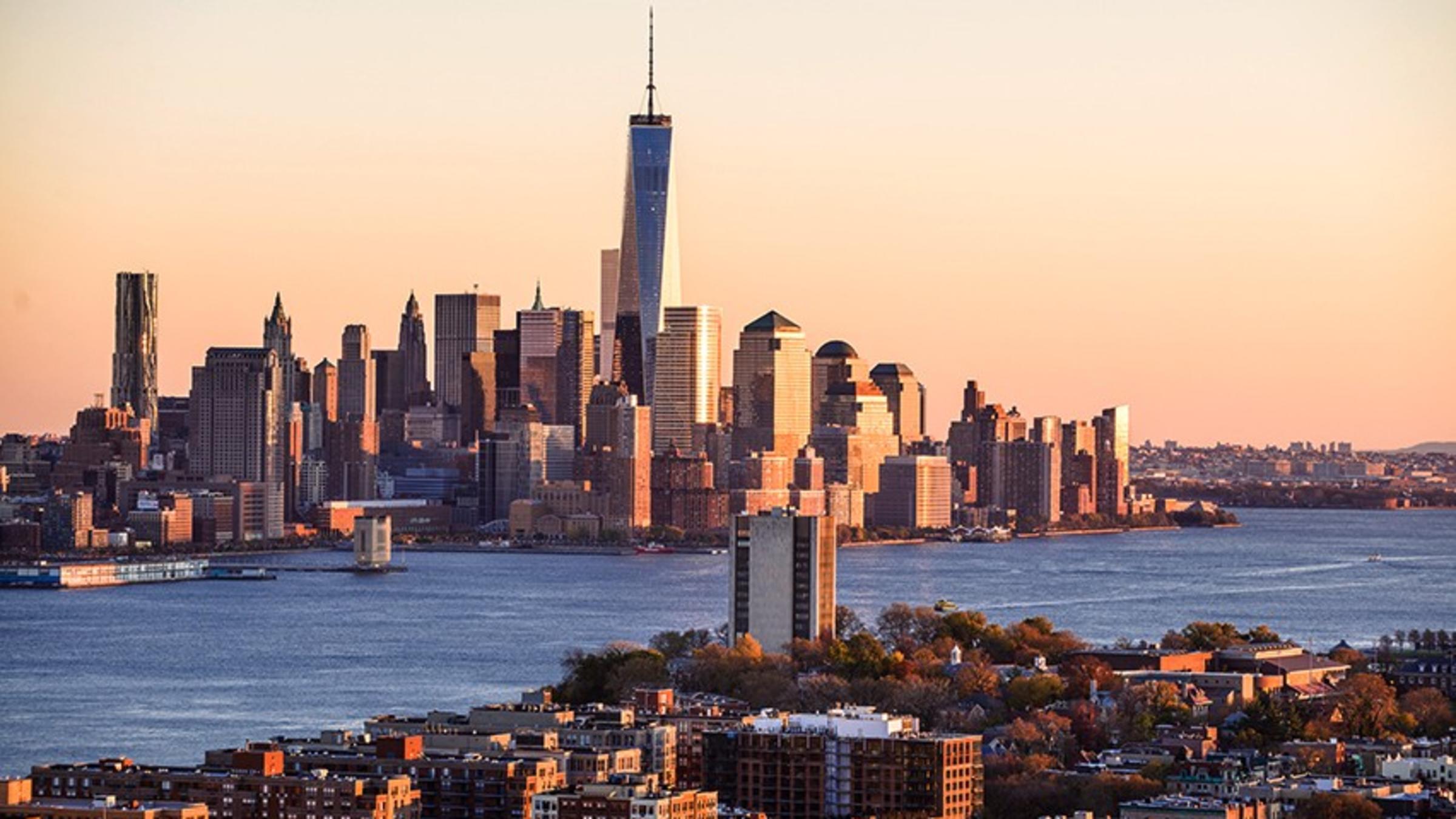 The Stevens campus and downtown New York City skyline at sunset.
