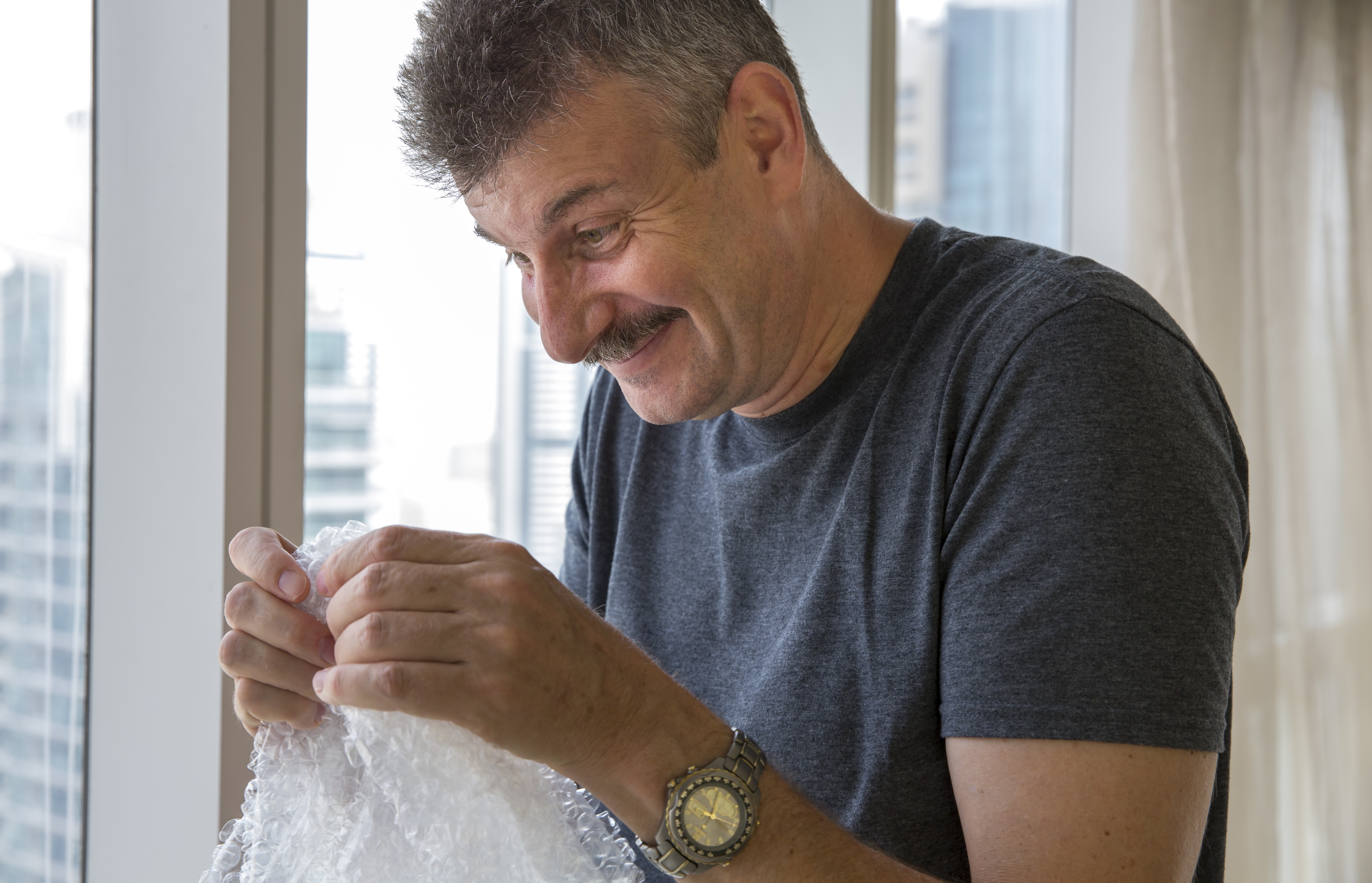 Man popping bubble wrap