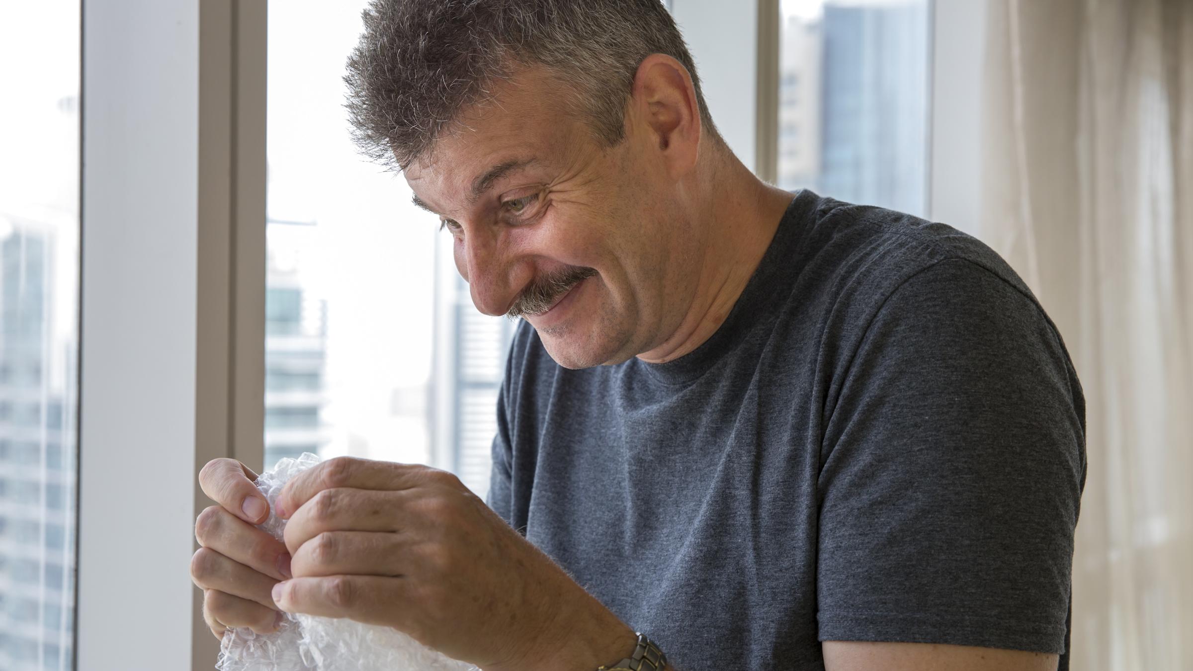 Man popping bubble wrap
