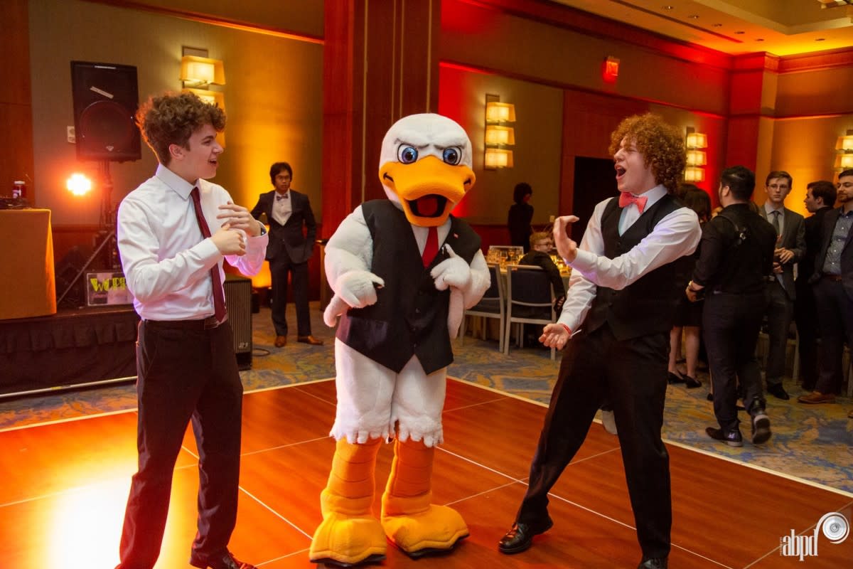 Attila on the dance floor with two students 