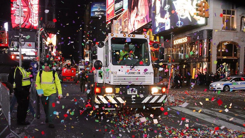 A sanitation truck collects garbage in Times Square after the crowds leave early on New Year's Day.