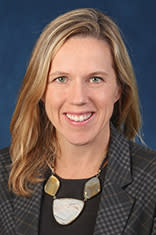 Ann Murphy against a blue background.