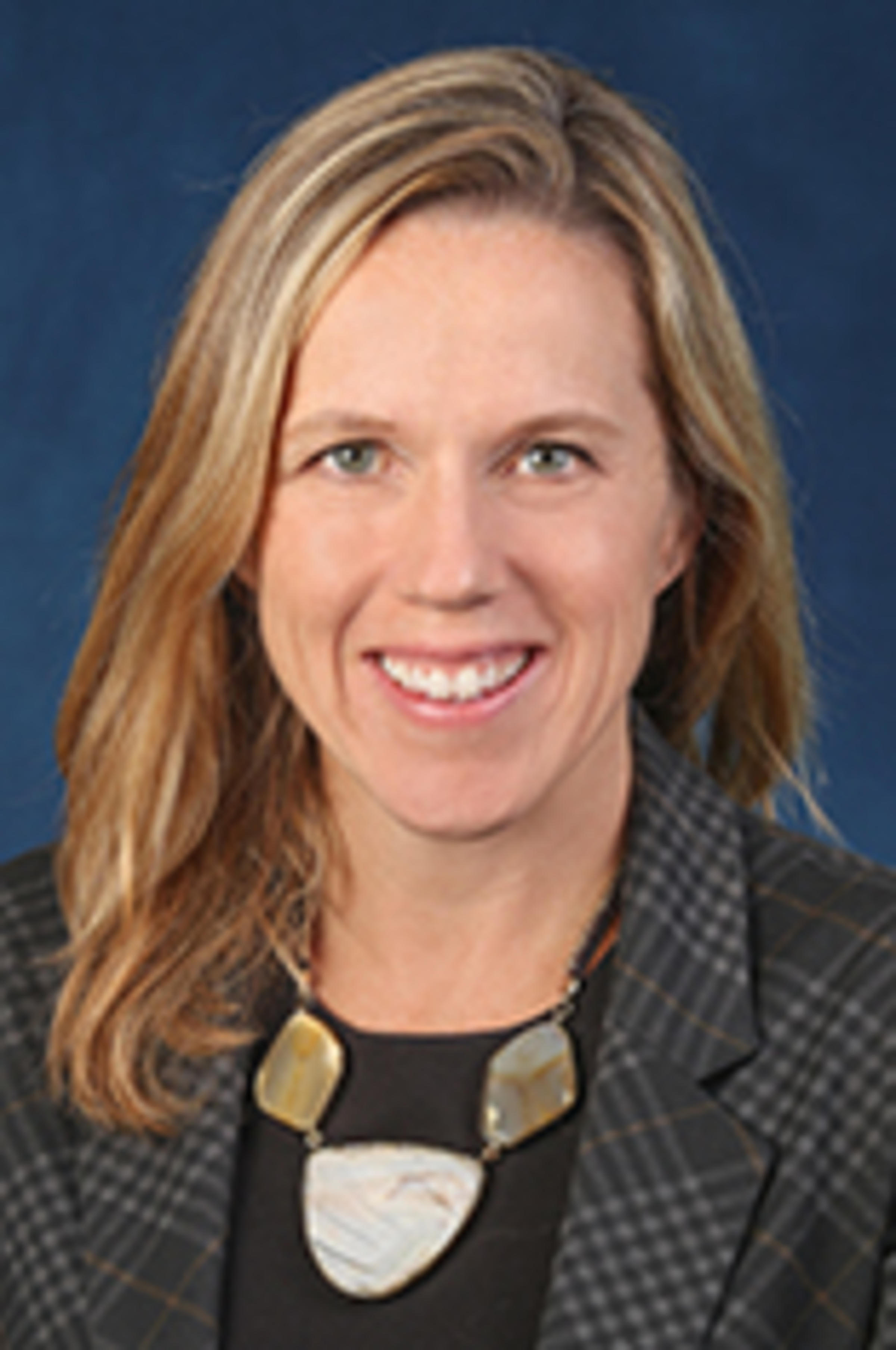 Ann Murphy against a blue background.