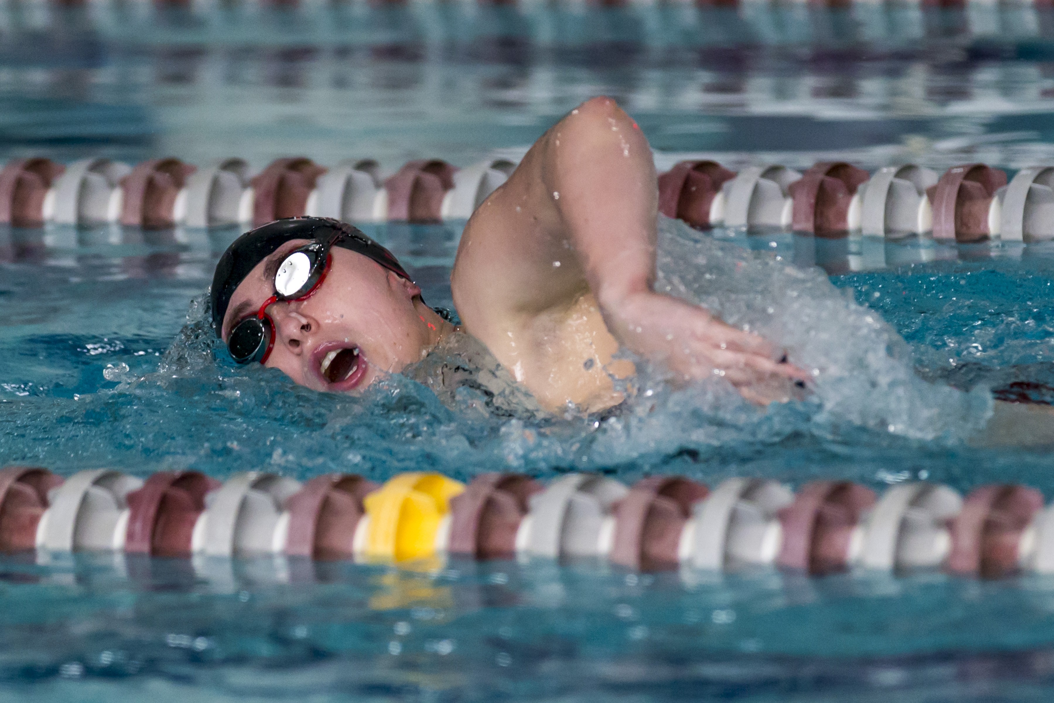 student swimmer competing in pool