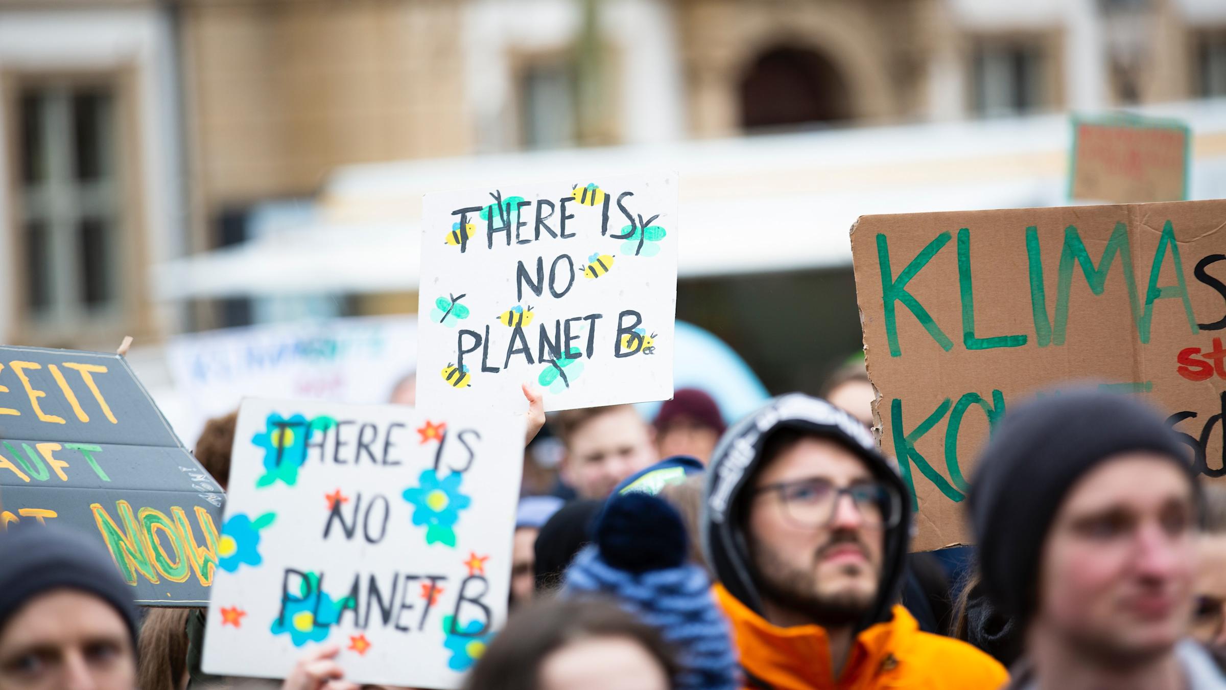 activists with signs that say "there is no planet b"
