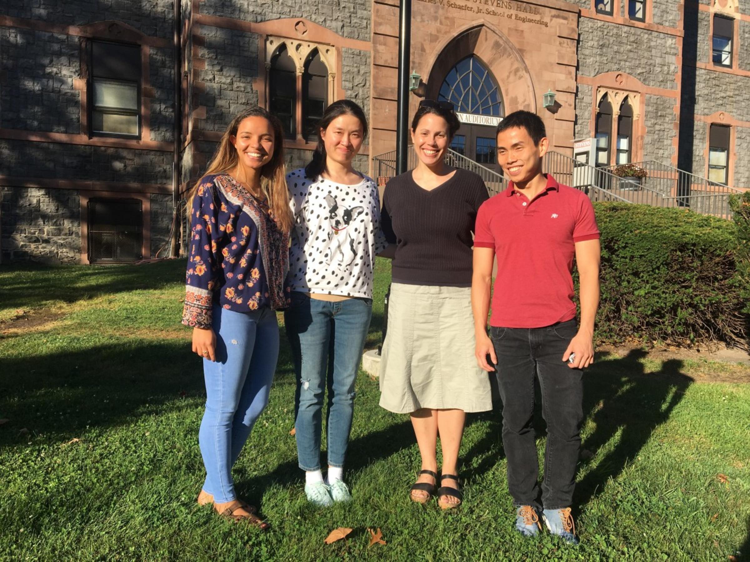 Perlman standing with students