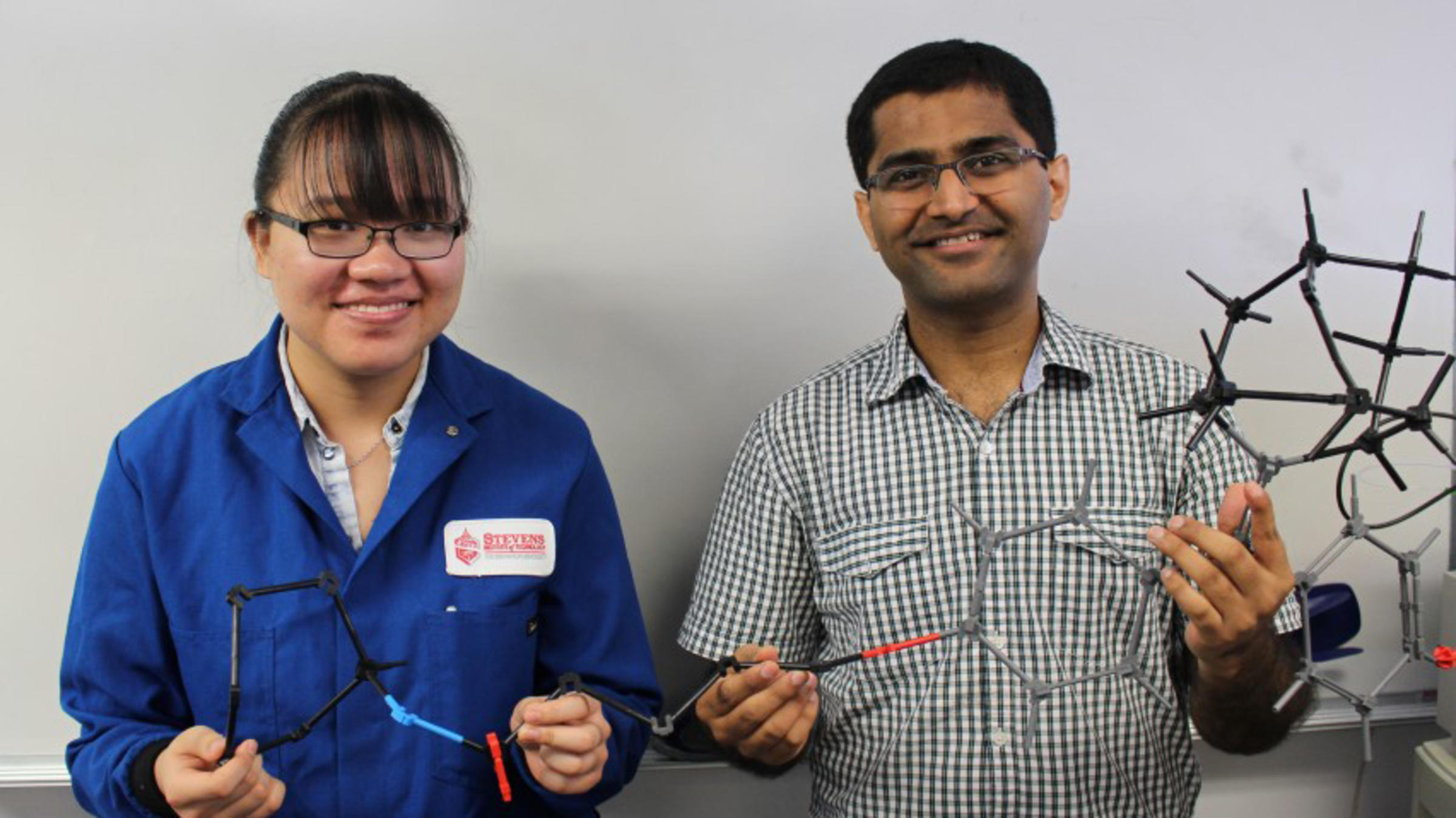 Stevens graduate student Lucia Wang and professor Abhishek Sharma with a model of one of the novel estrogen-receptor (ER) antagonists identified in new research