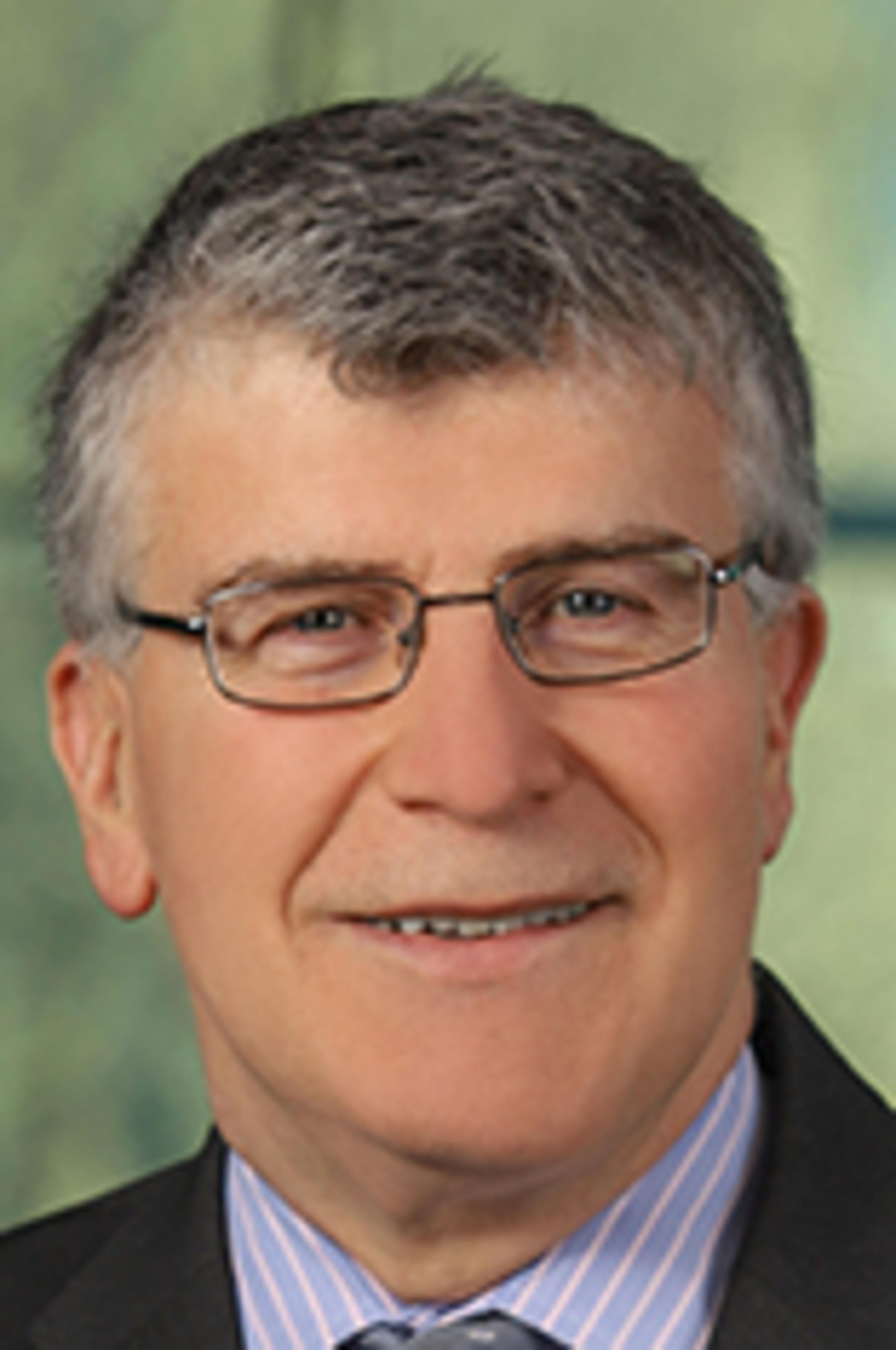 Headshot of Manos Hatzakis with the Manhattan skyline in the background.