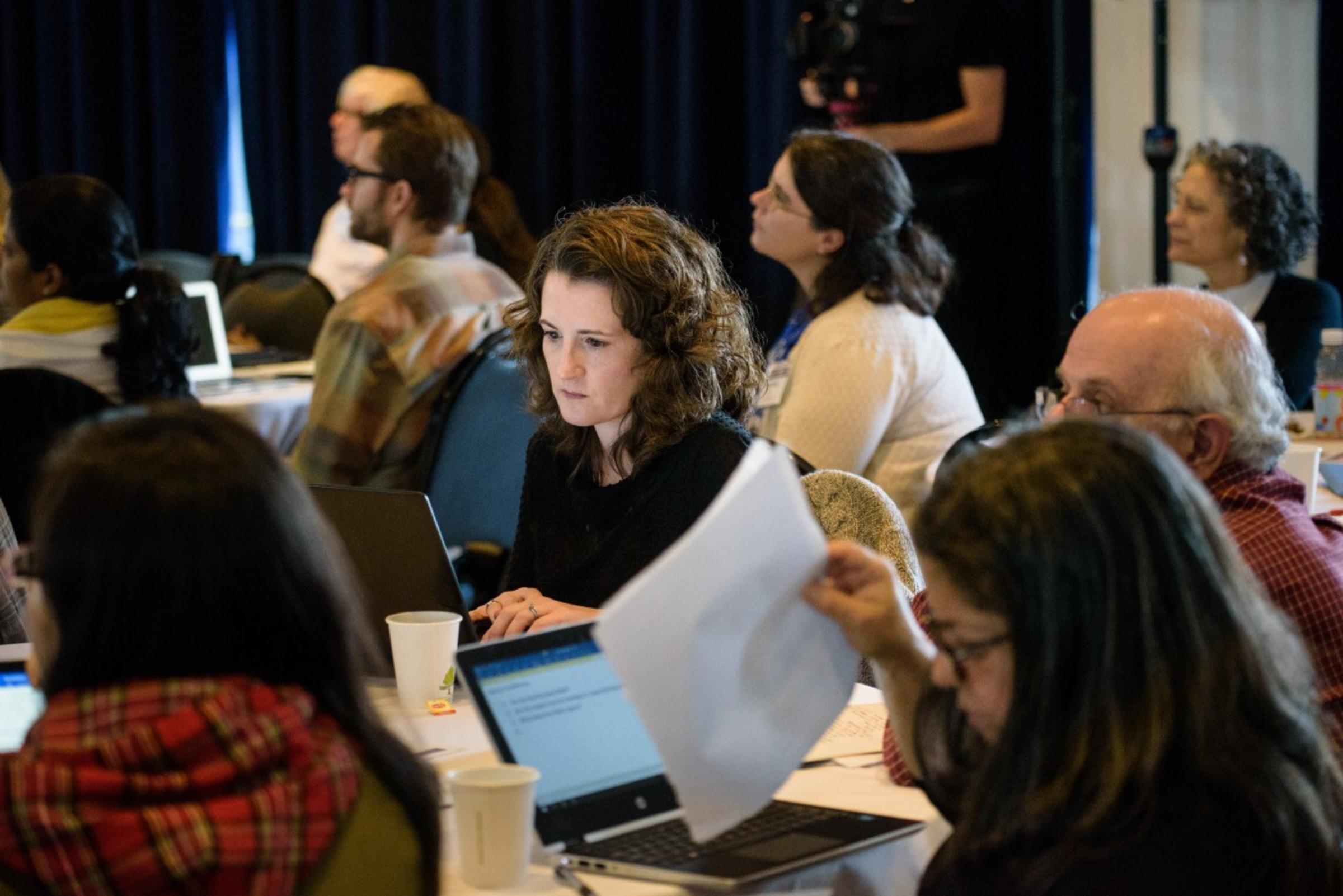 Conference attendees taking notes