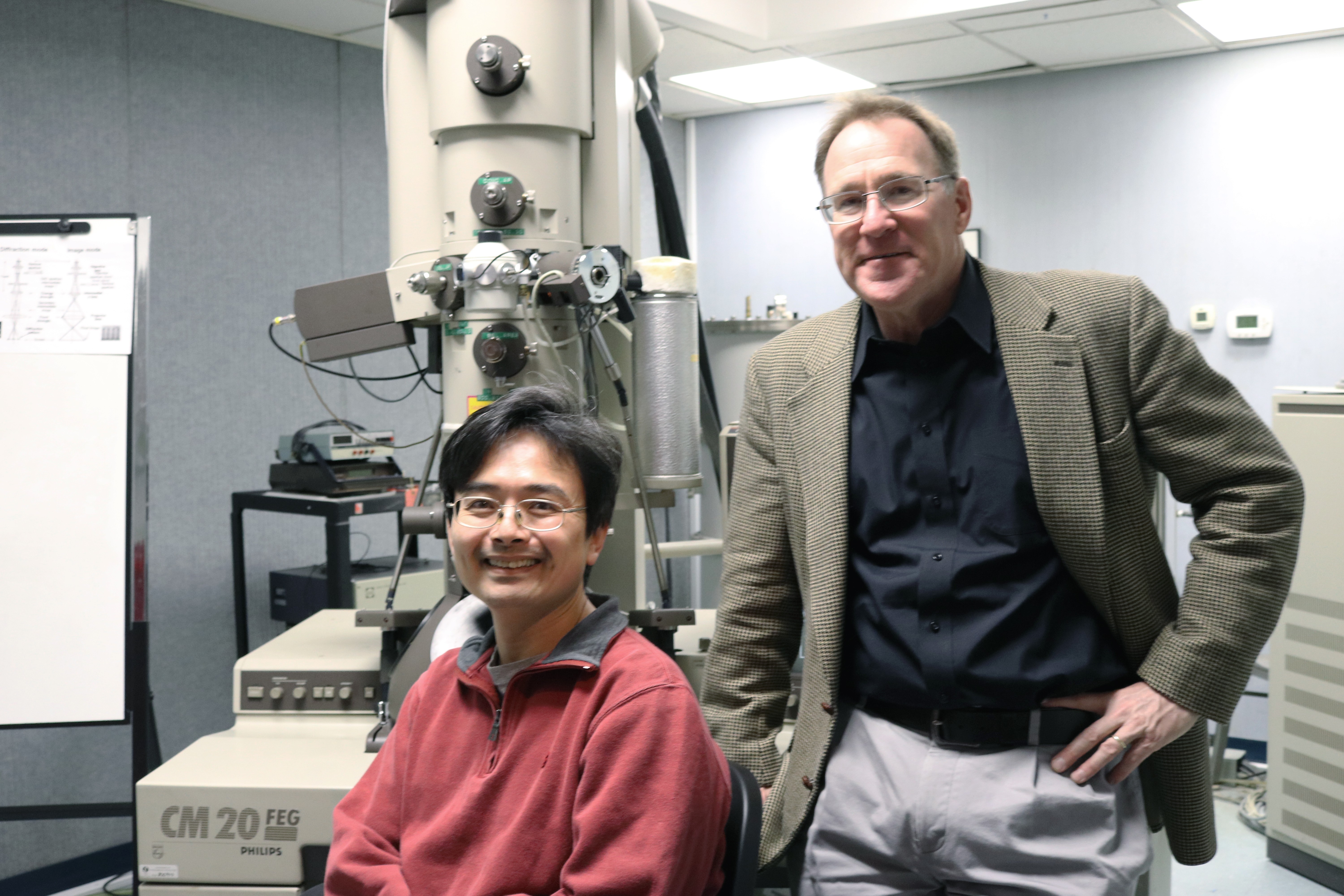 Research scientist Tsengming (Alex) Chou and professor Matthew Libera with the Philips CM20 field-emission transmission electron microscope. CREDIT: Stevens