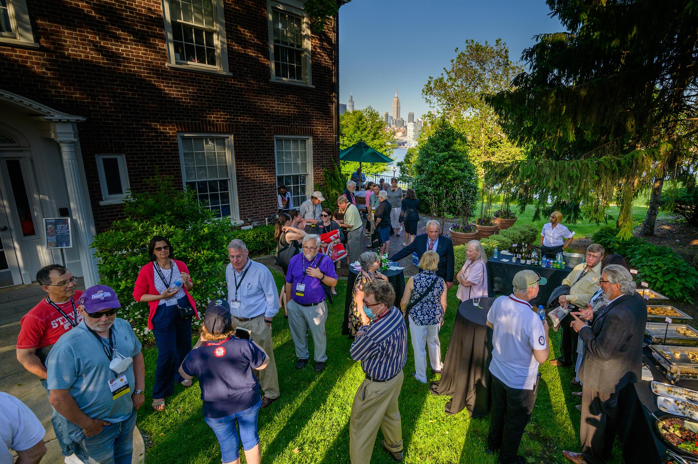 Alumni gather and mingle outside during Alumni Weekend