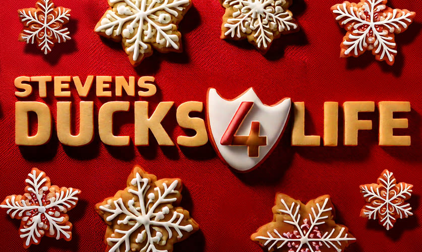 Holiday-themed graphic featuring the text “Stevens Ducks 4 Life” surrounded by decorated snowflake-shaped cookies on a red background.