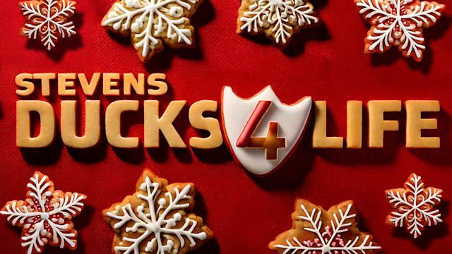 Holiday-themed graphic featuring the text “Stevens Ducks 4 Life” surrounded by decorated snowflake-shaped cookies on a red background.