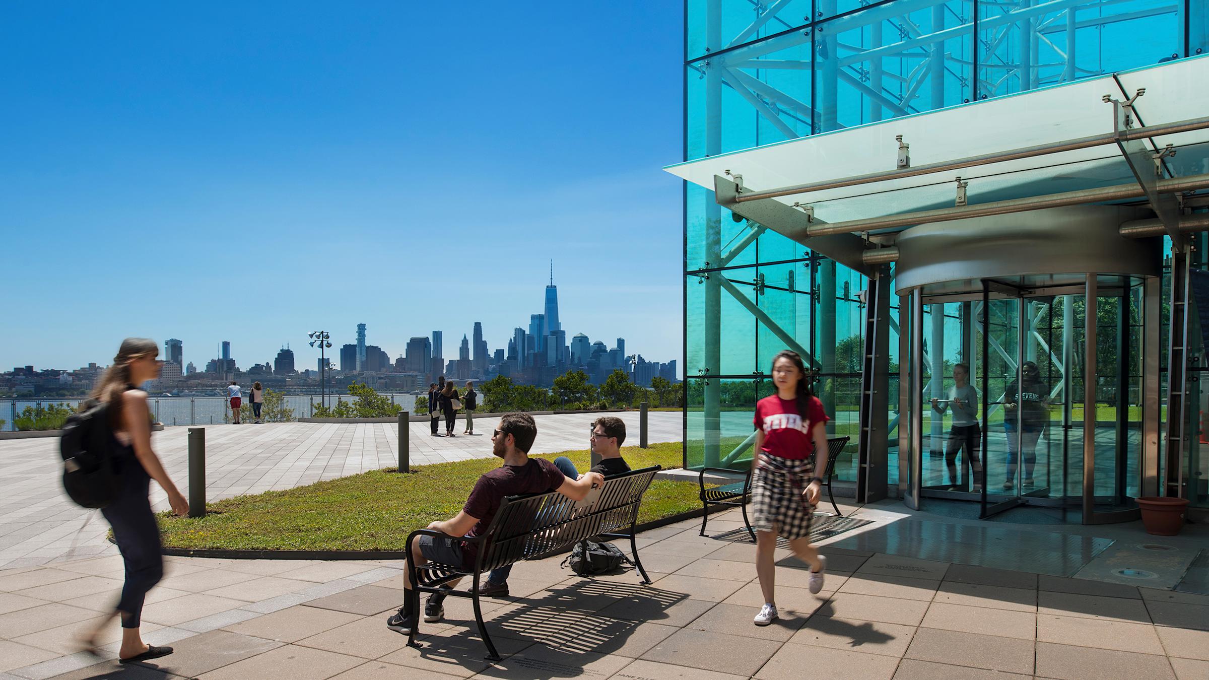 Students outside Babbio building with New York city in background.