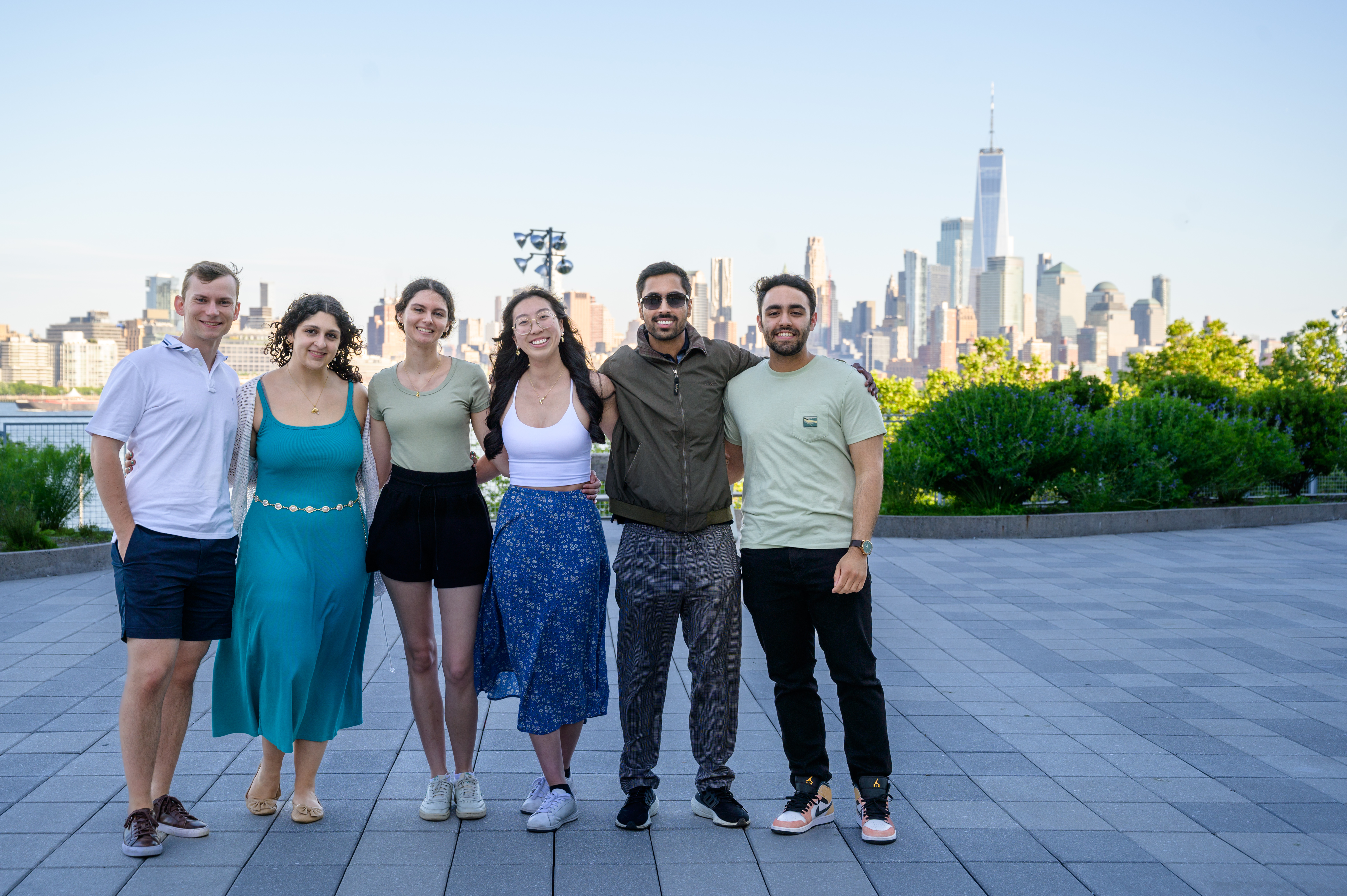 Group of young alumni pose for a picture on the Babbio patio during Alumni Weekend in 2024