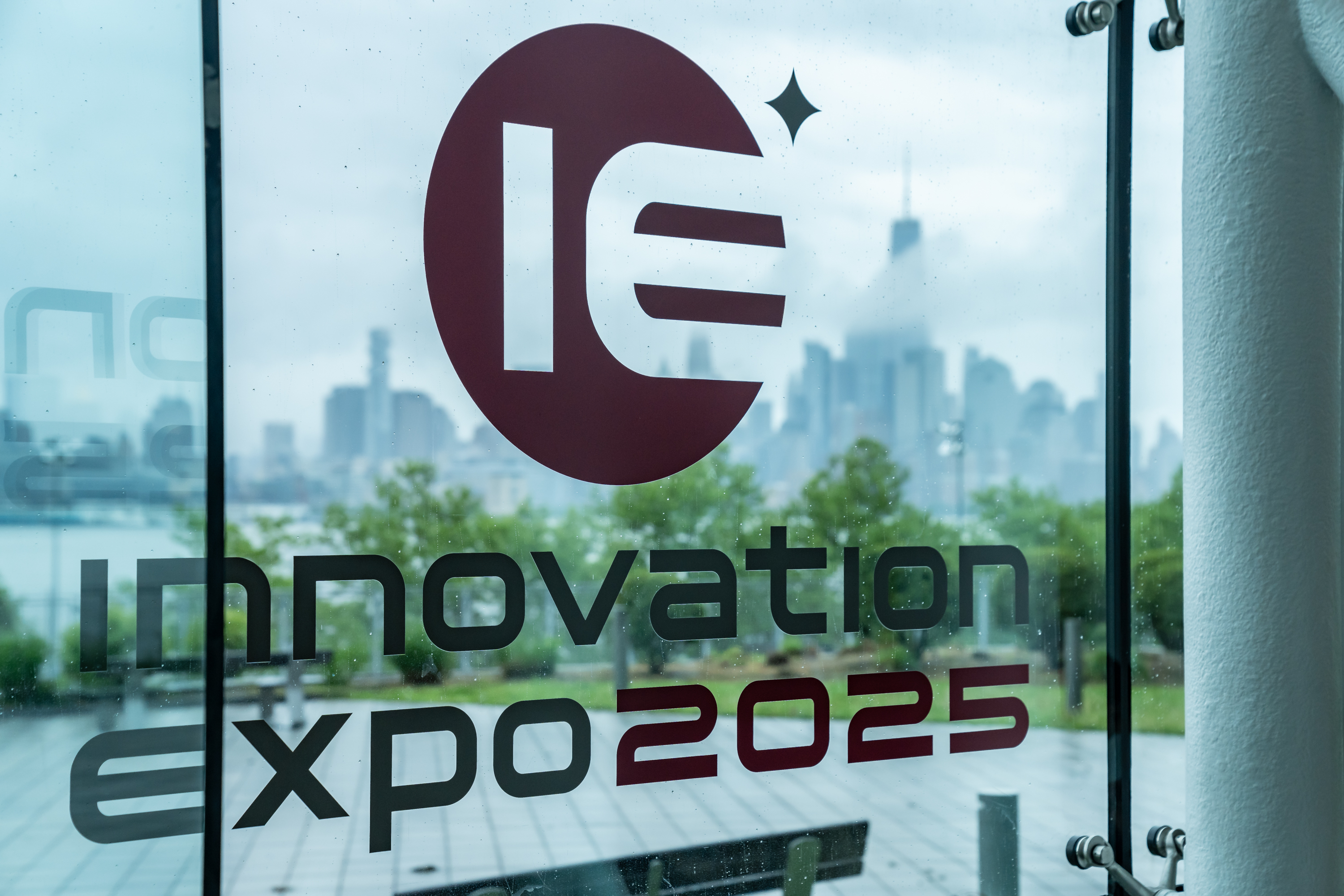 The Innovation Expo 2025 Logo posted on a clear glass window.