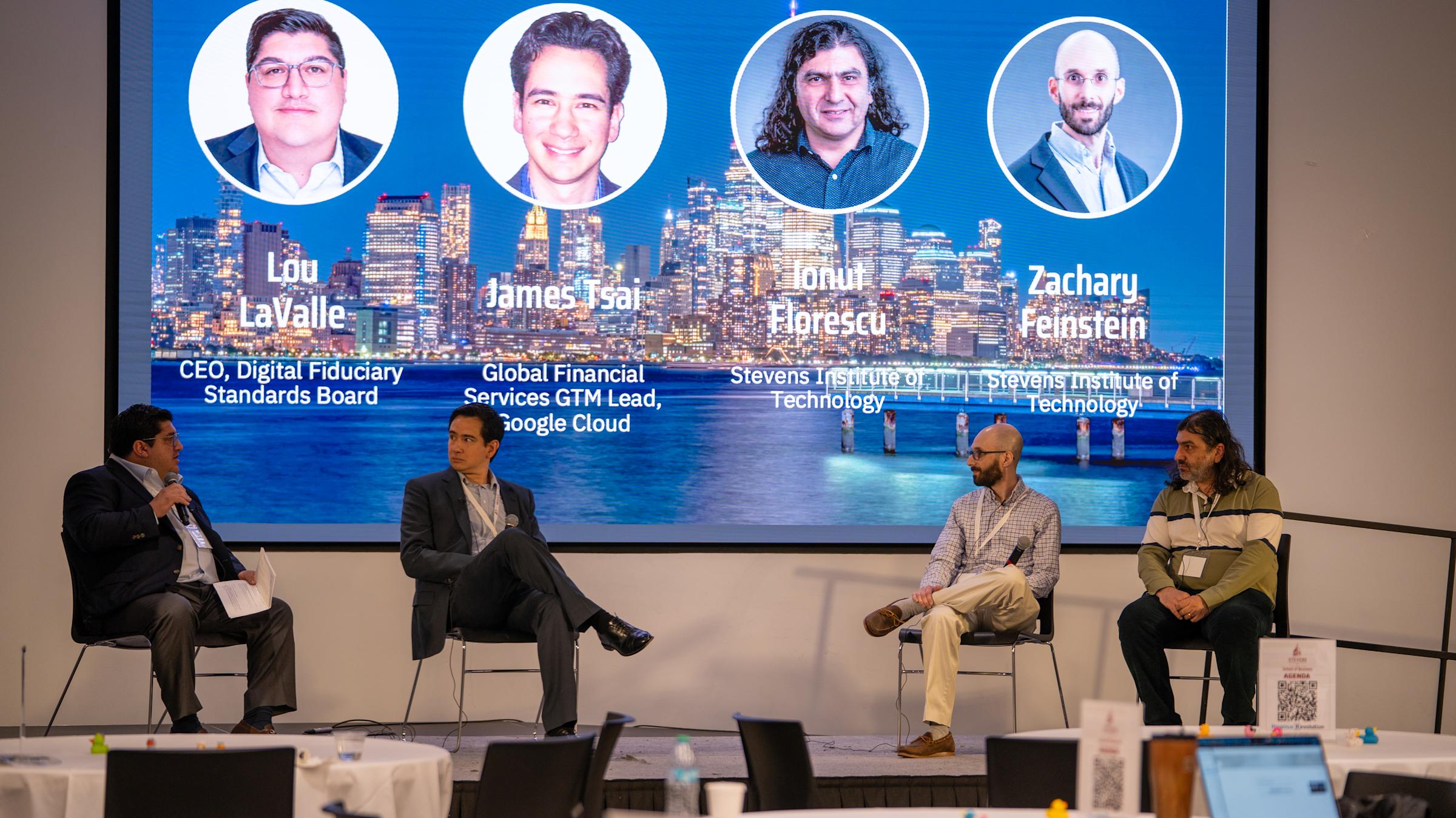 our panelists sit on stage beneath large screen showing headshots and credentials: Lou LaValle (CEO, Digital Fiduciary Standards Board), James Tsai (Google Cloud GTM Lead), Ionut Elprescu (Stevens), and Zacharu Feinstein (Stevens).
