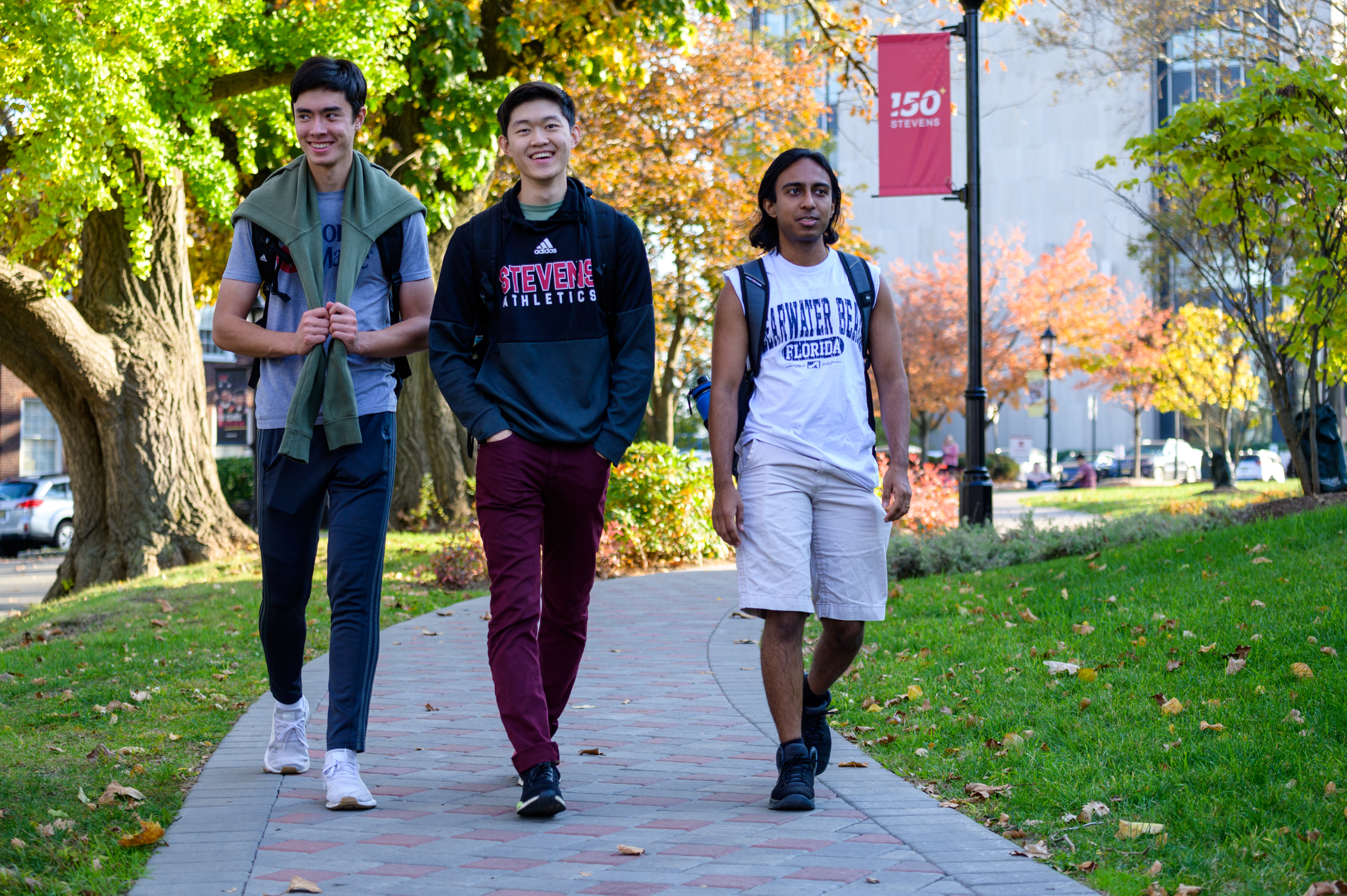 3 male students walking on Campus