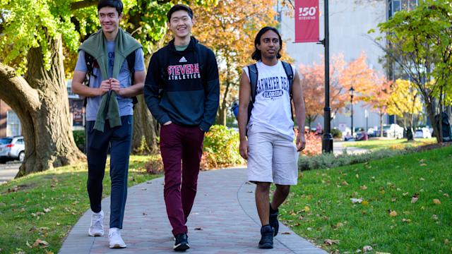 3 male students walking on Campus