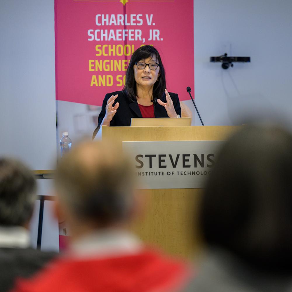 Rebecca Li speaking to audience members behind a podium.