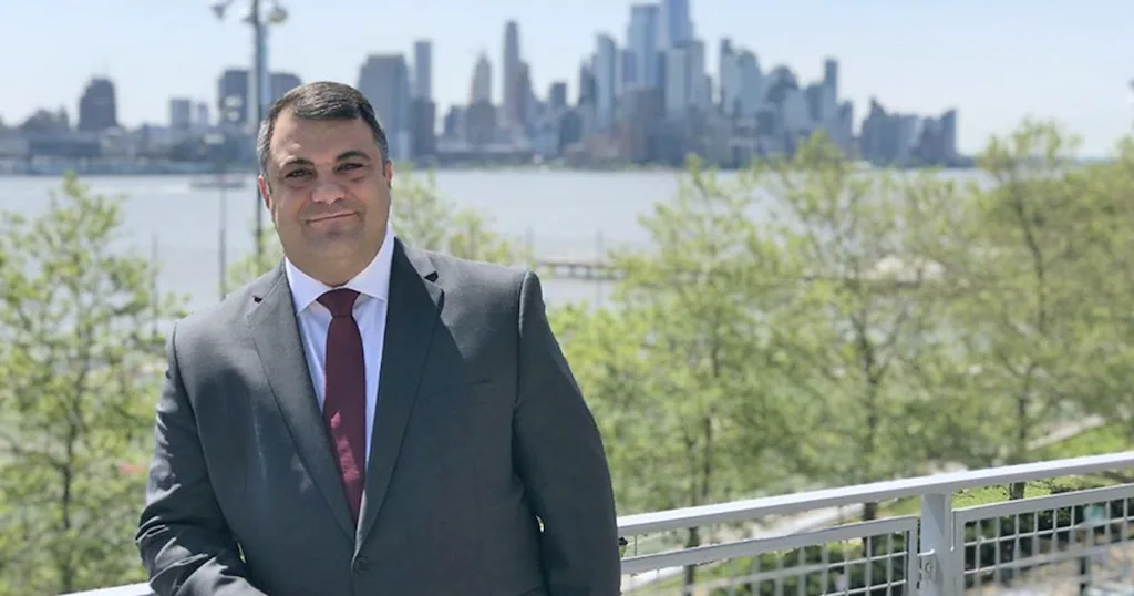 Chris Colla in front of the NYC skyline