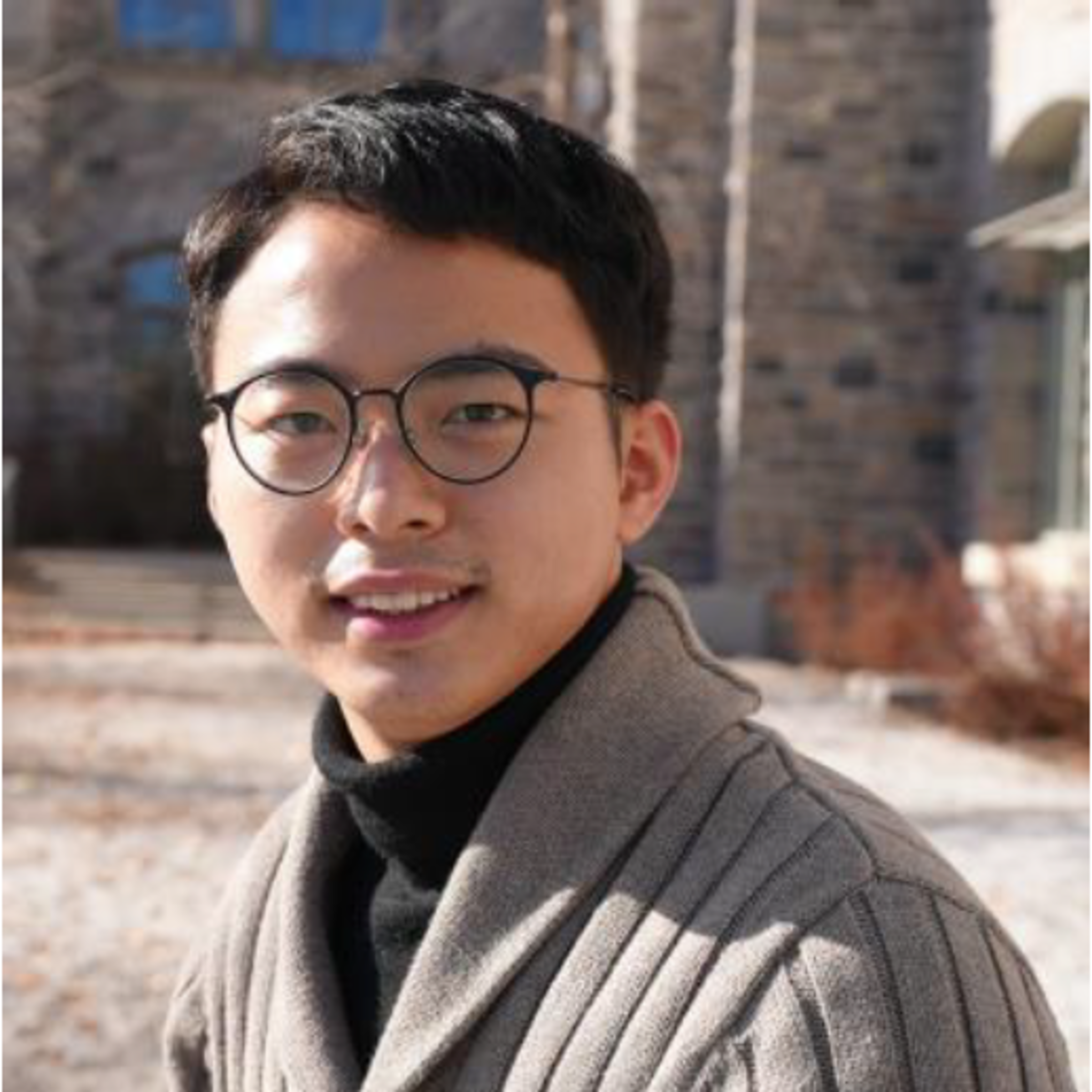 Headshot of Jia Mi wearing glasses and smiling, outside