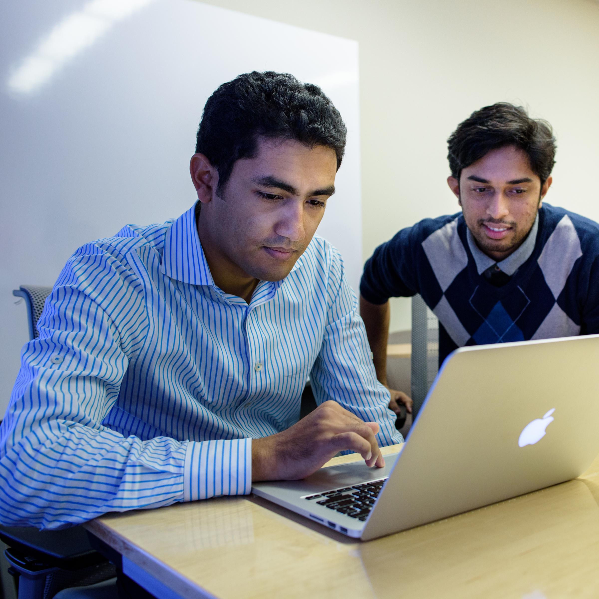 students looking at a laptop in class