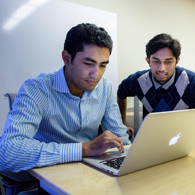 students looking at a laptop in class