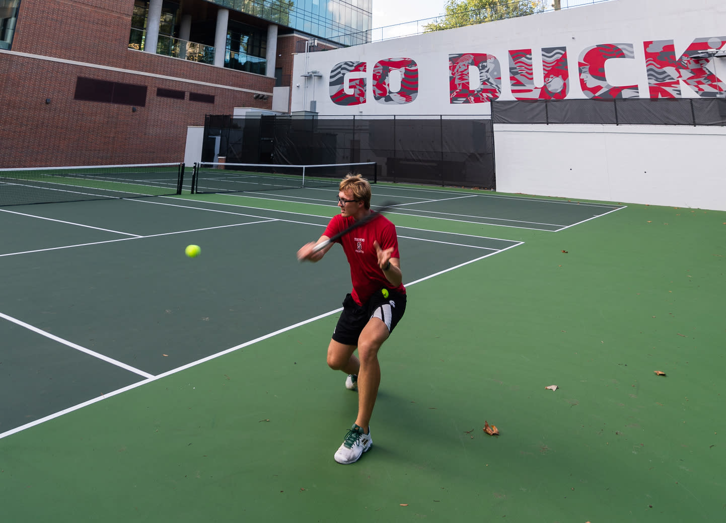 Tennis player about to hit tennis ball.