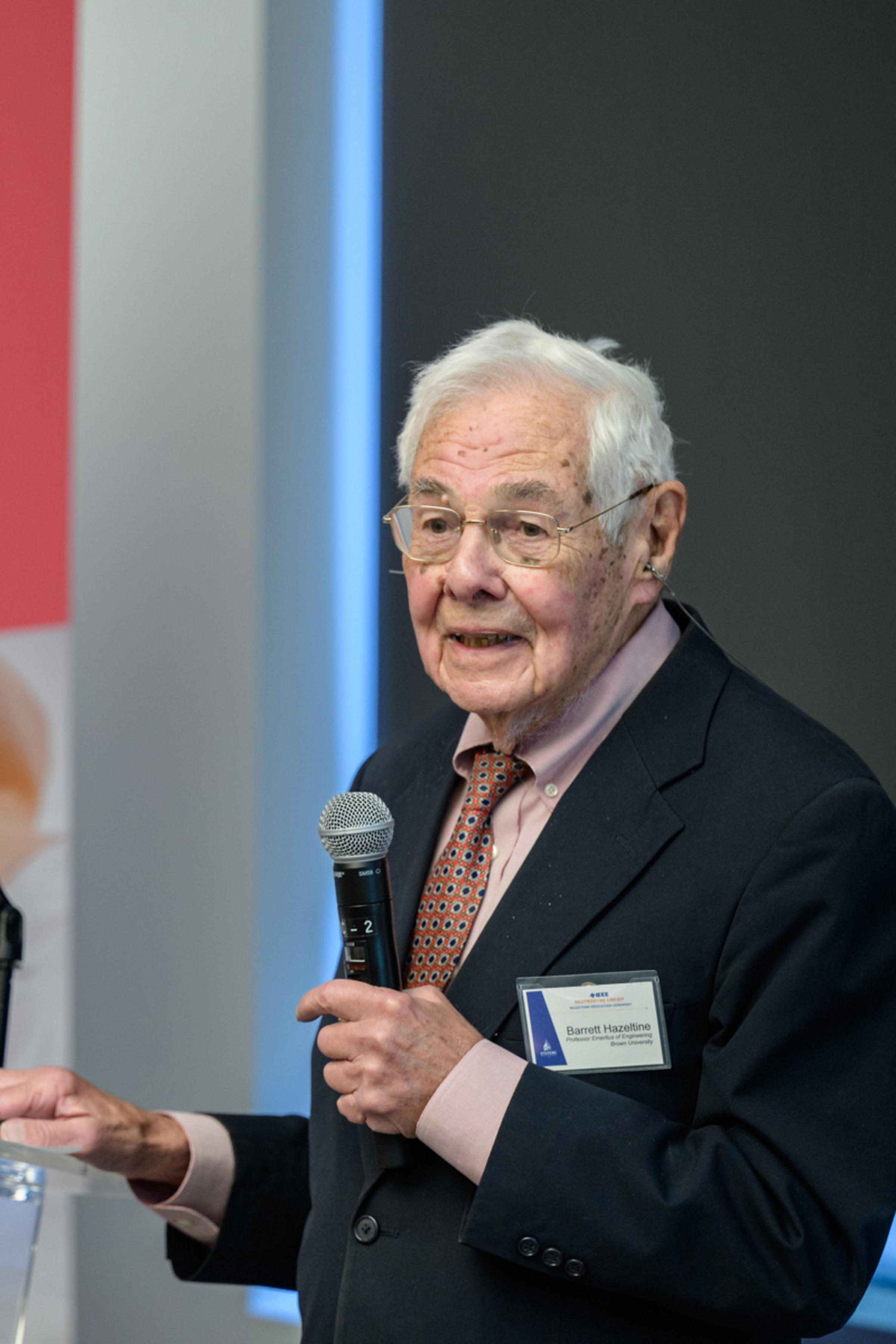 Barrett Hazeltine speaks into a microphone.