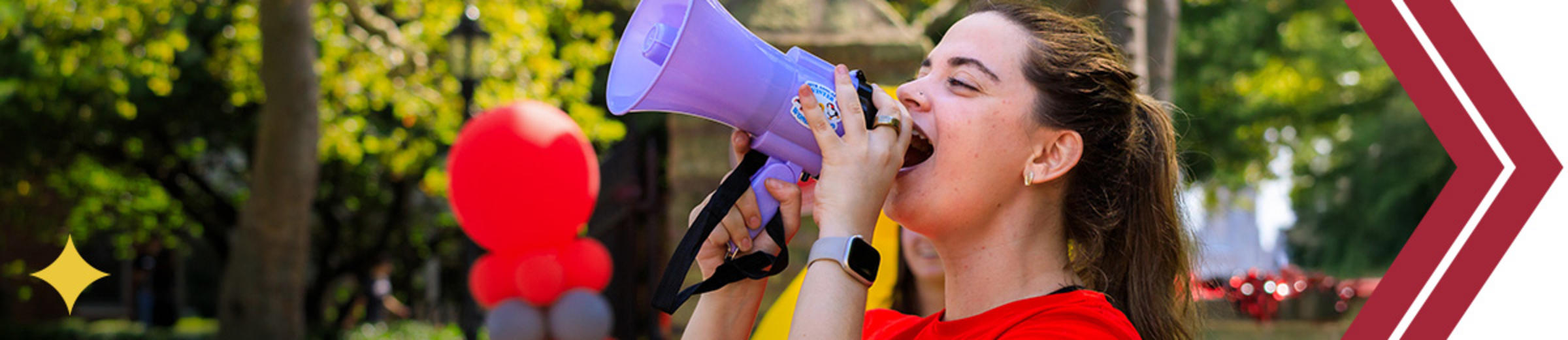 Student yelling into a loudspeaker.